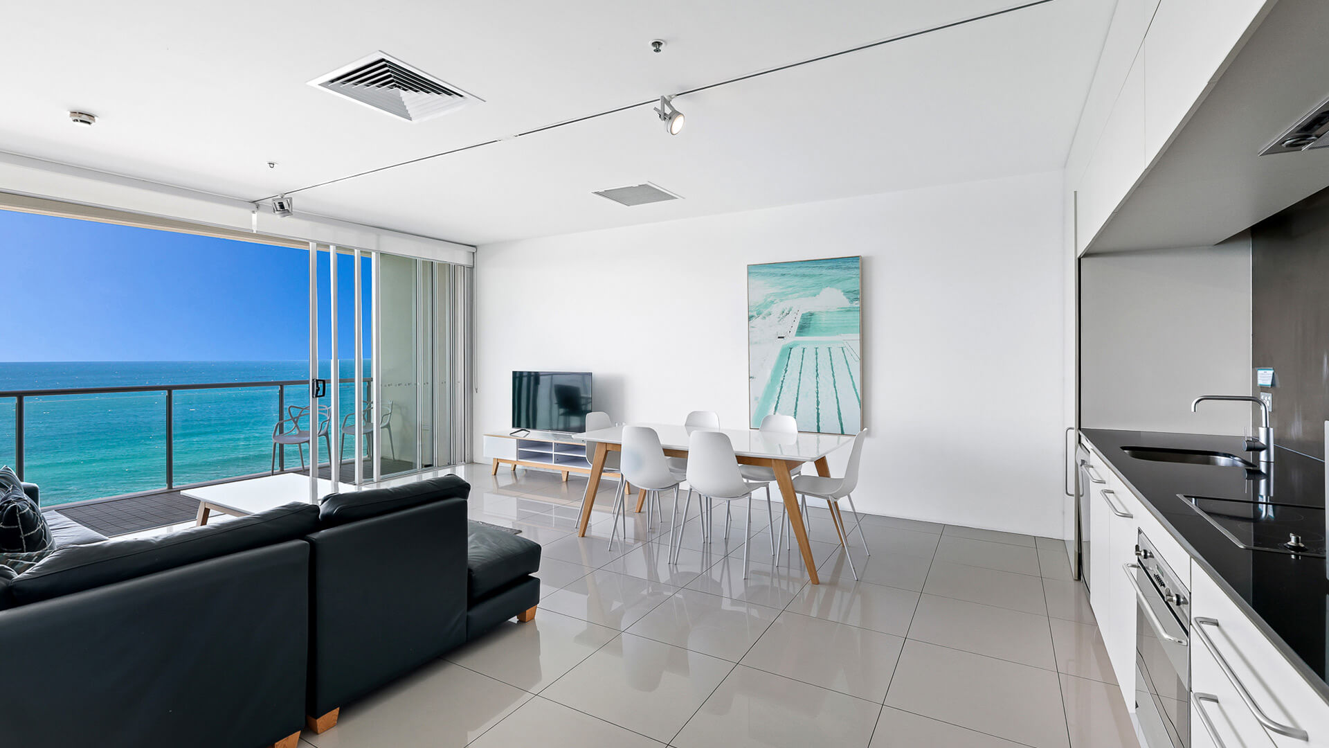Open-plan living, dining, and kitchen with ocean views in 2 Bedroom Ocean View Apartment at ULTIQA Air on Broadbeach.