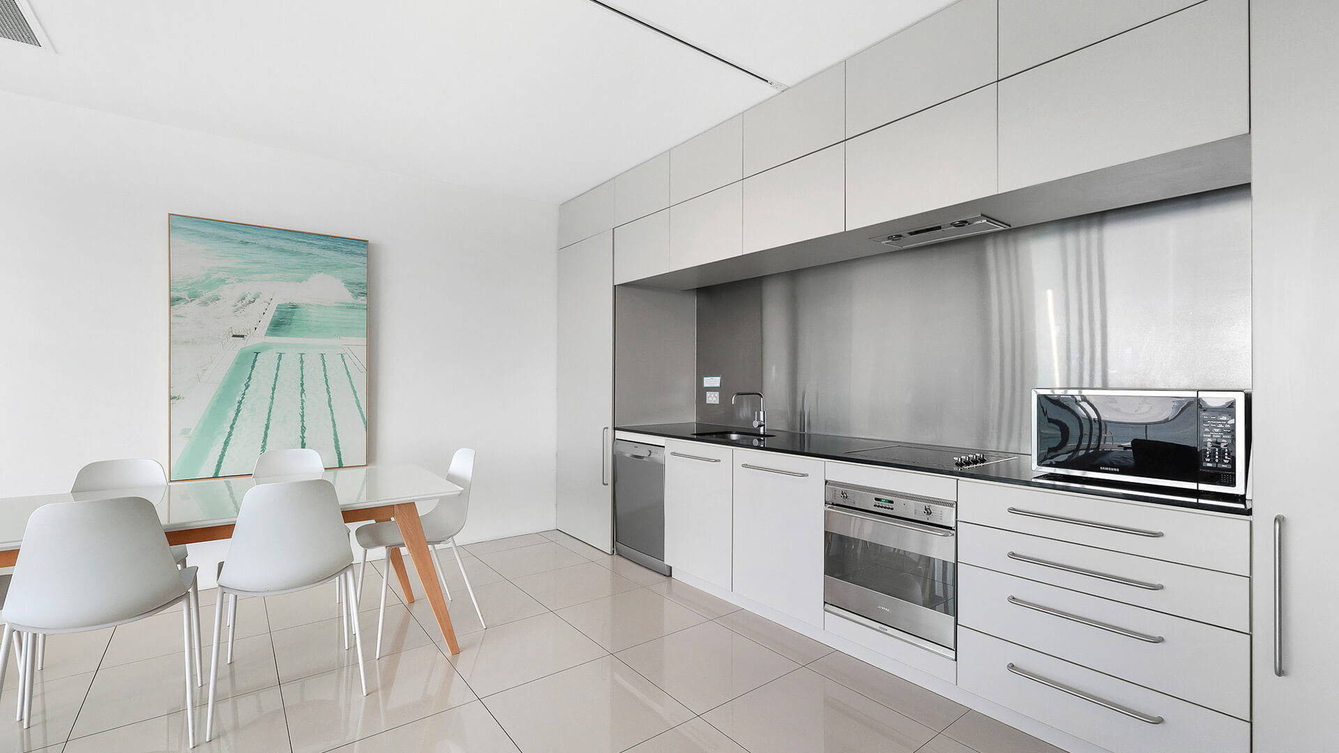 Modern kitchen and dining area in the 2 Bedroom Ocean View Apartment at ULTIQA Air on Broadbeach.