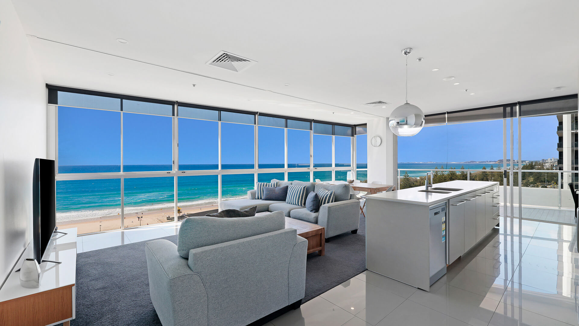 Spacious living area with panoramic ocean views in the 2 Bedroom Ocean View Suite at ULTIQA Air on Broadbeach.