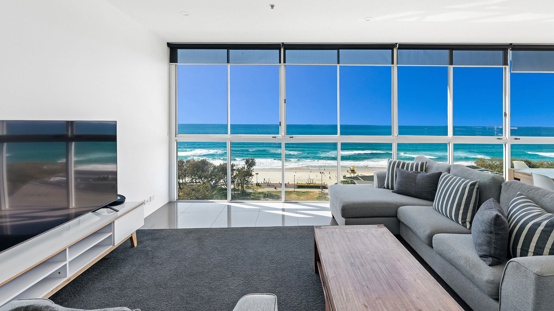 Living room with floor-to-ceiling ocean views in 2 Bedroom Ocean View Suite at ULTIQA Air on Broadbeach.