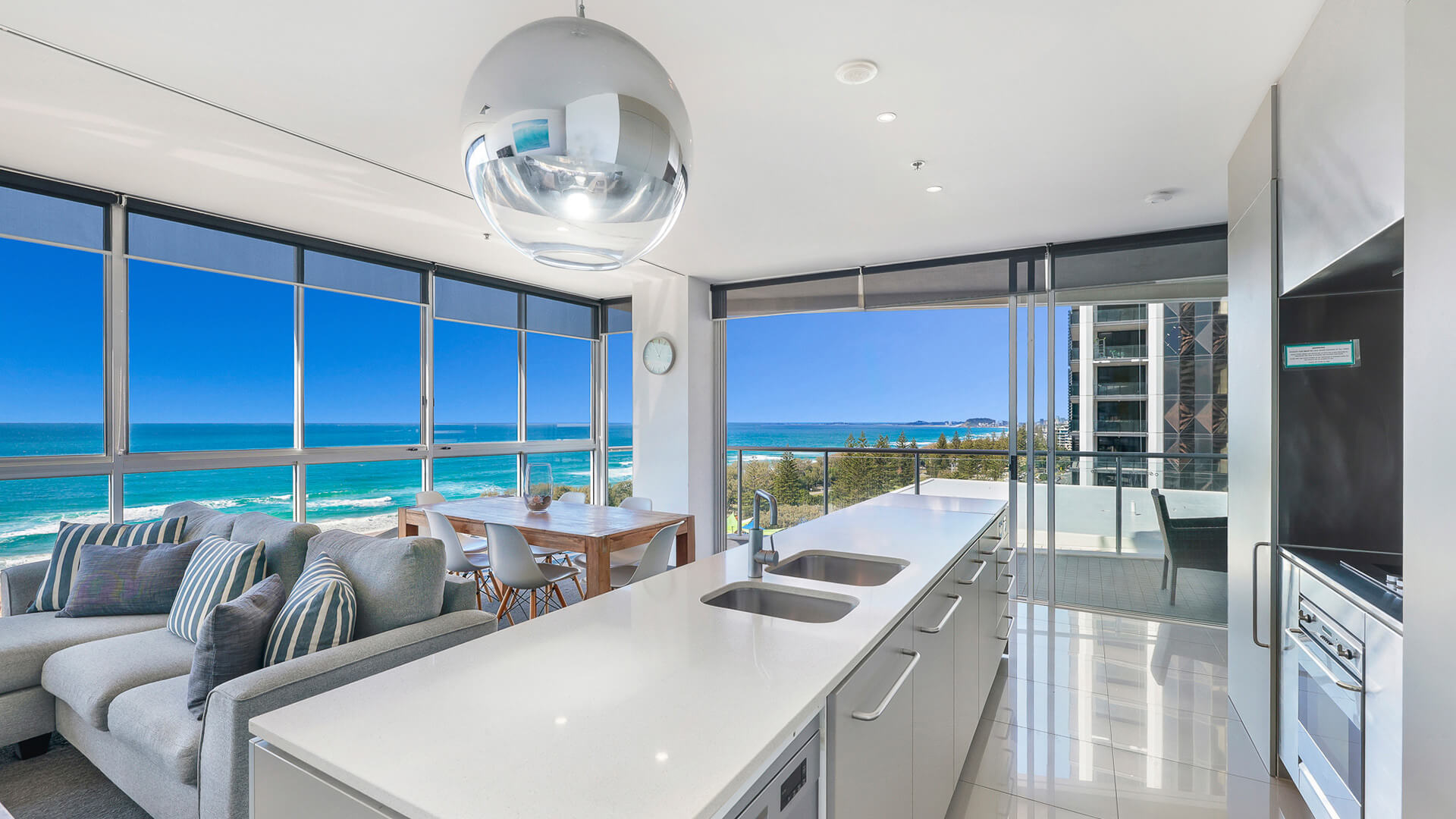Modern kitchen and dining with ocean views in 2 Bedroom Ocean View Suite at ULTIQA Air on Broadbeach.
