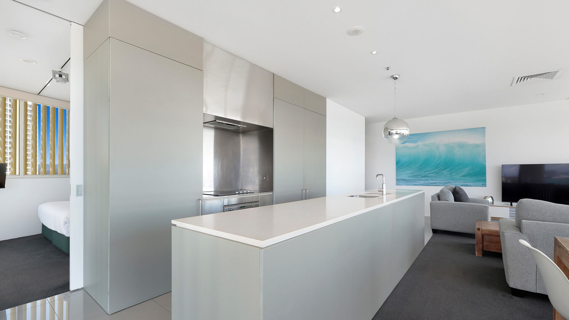 Modern kitchen with open-plan living in 2 Bedroom Ocean View Suite at ULTIQA Air on Broadbeach.