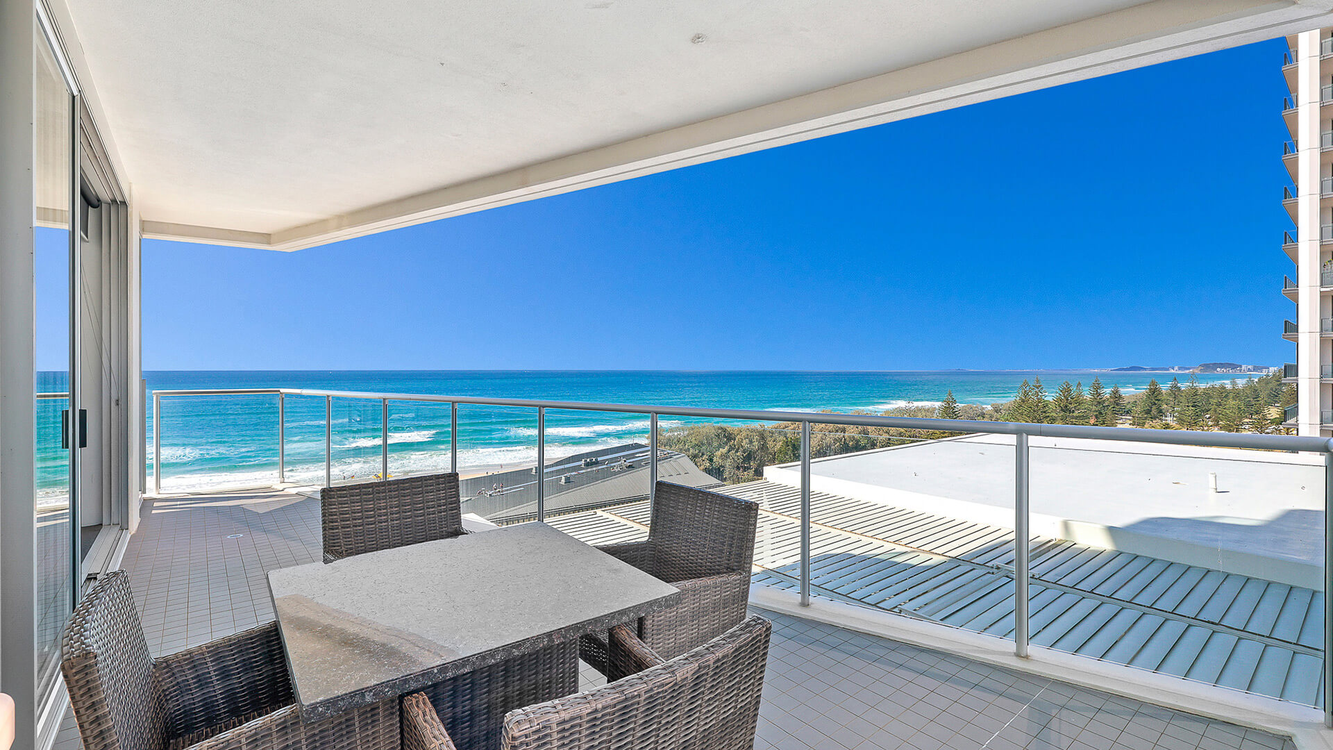 Private balcony with outdoor dining and ocean views in 2 Bedroom Ocean View Suite at ULTIQA Air on Broadbeach.
