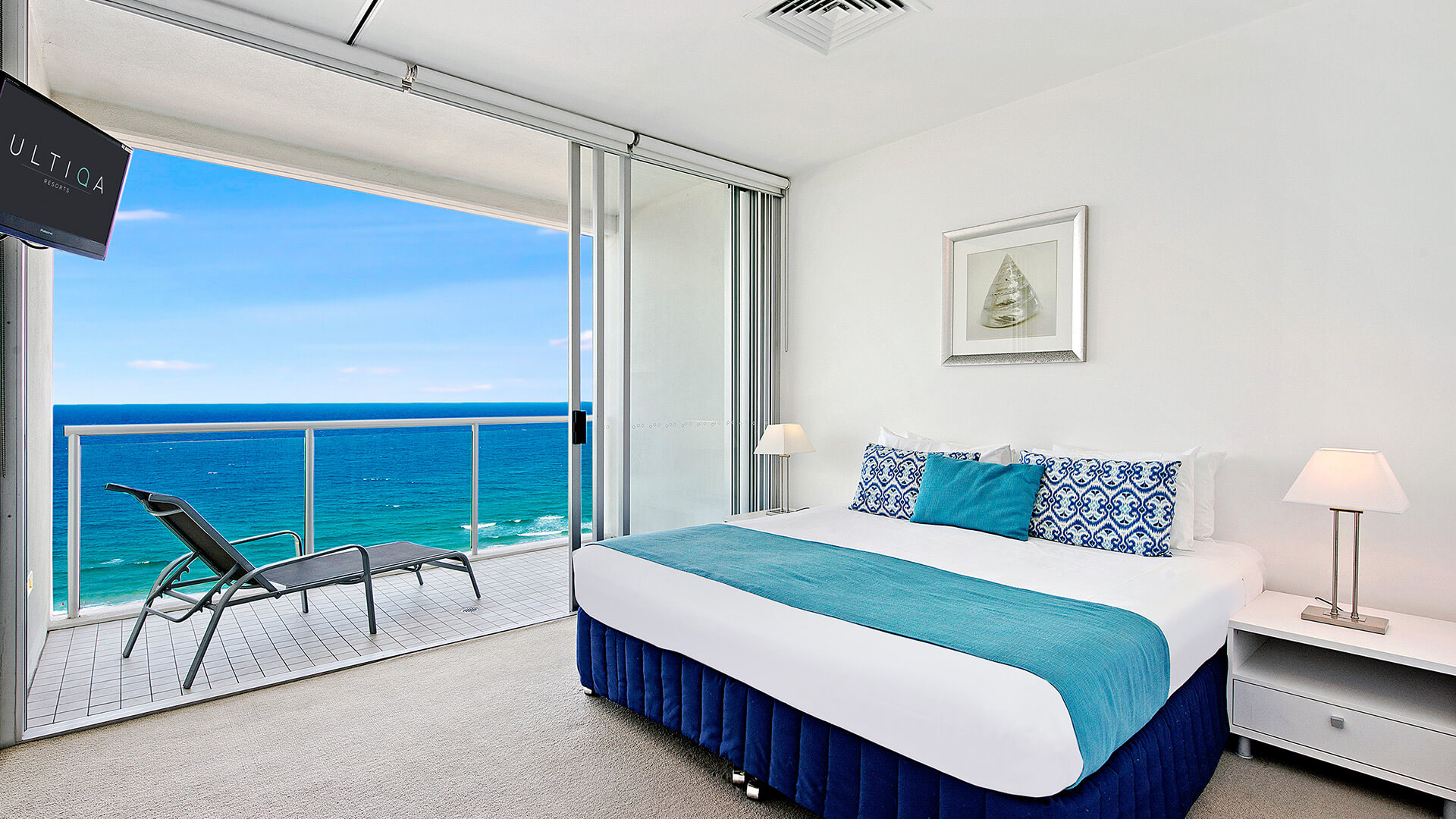 Master bedroom with king bed and private balcony offering ocean views – 2 Bedroom Ocean View Suite at ULTIQA Air on Broadbeach.