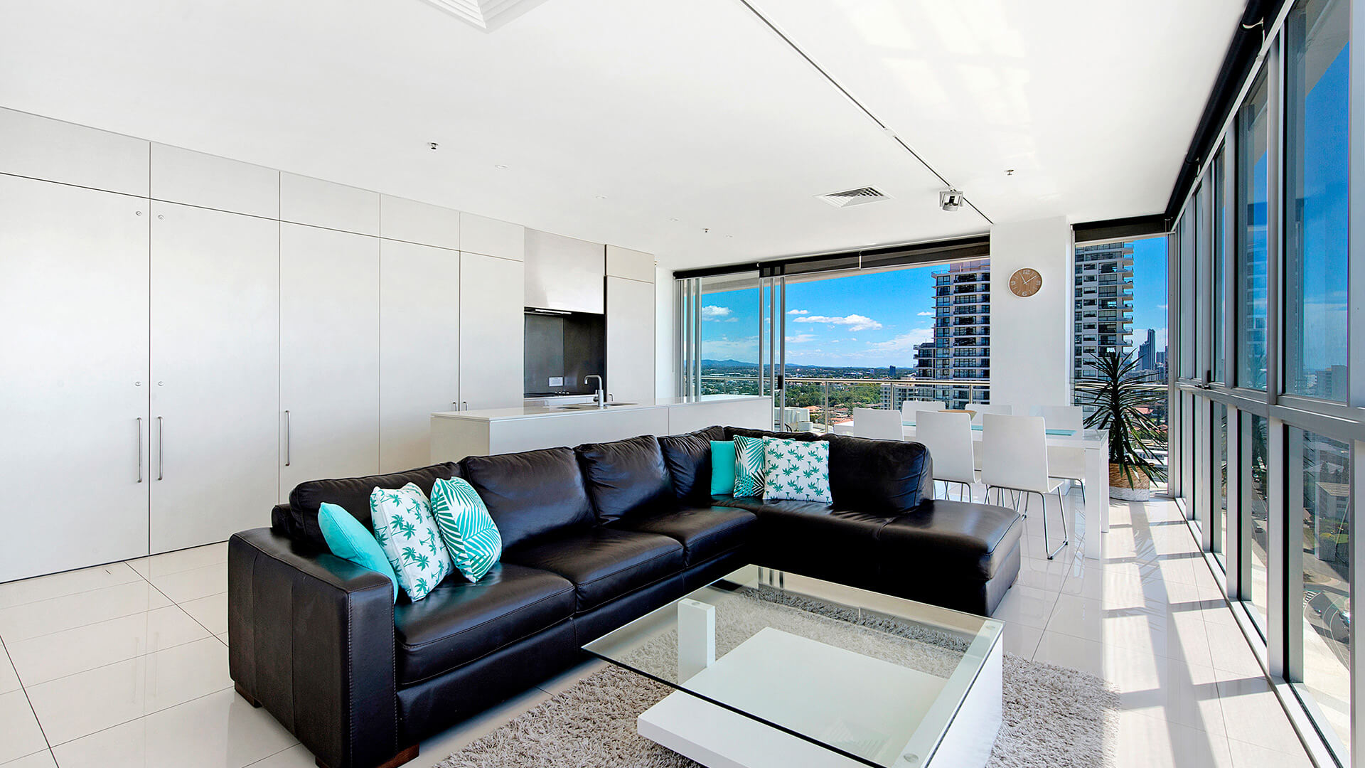 Spacious lounge and dining area with city and hinterland views in 3 Bedroom Apartment at ULTIQA Air on Broadbeach.