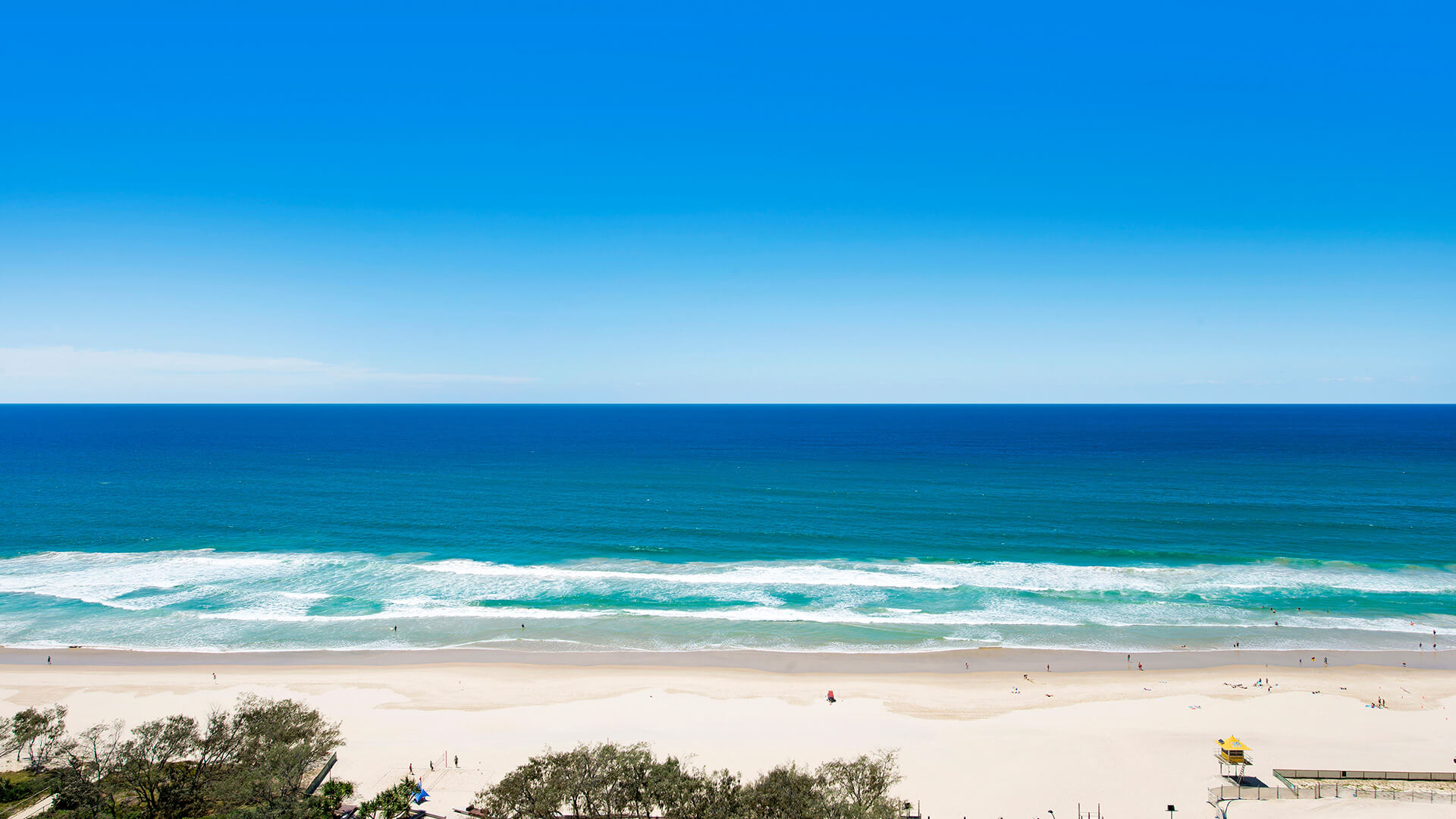 Direct oceanfront view from ULTIQA Air on Broadbeach overlooking golden sand and turquoise waves of the Gold Coast.