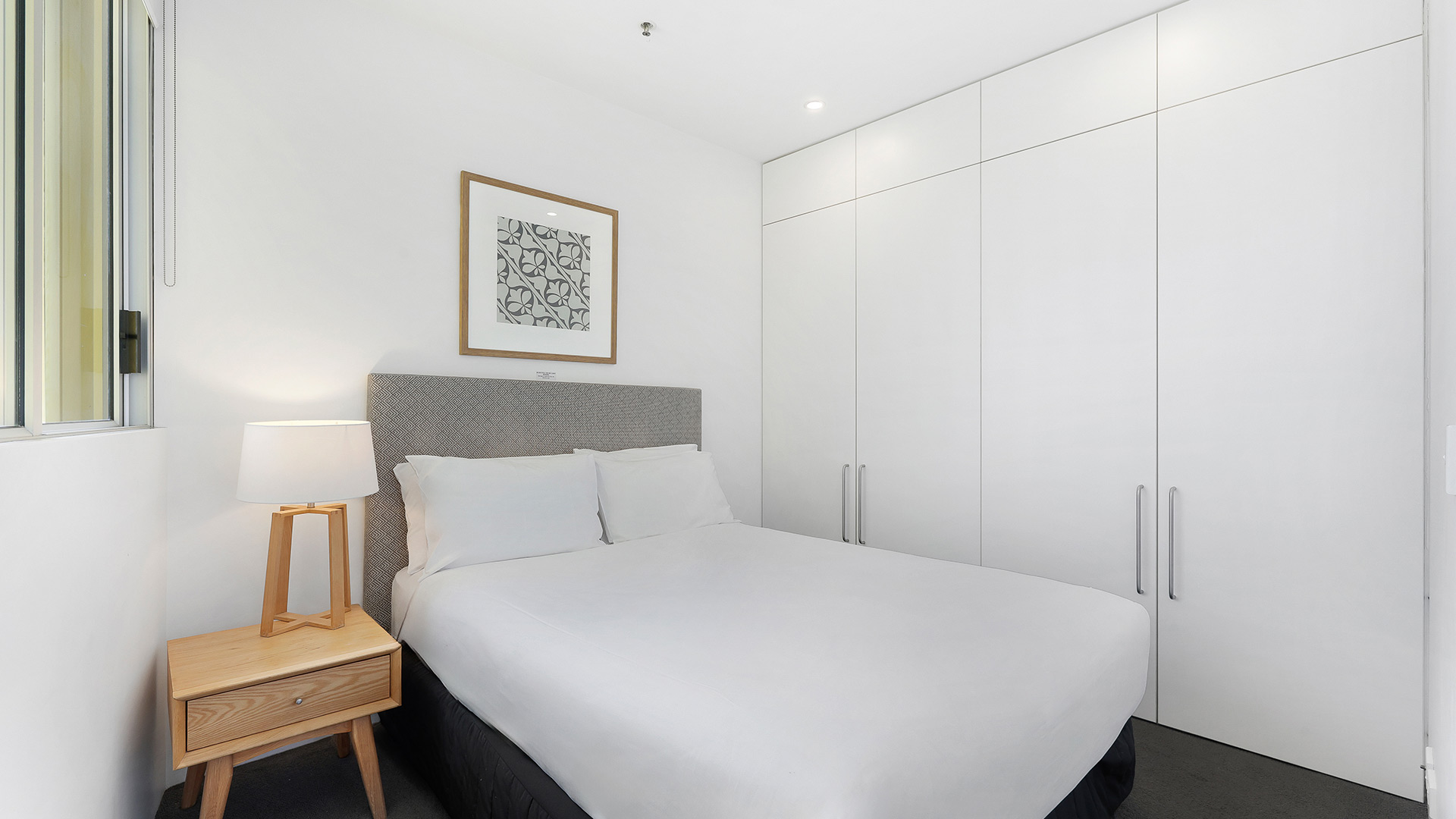 Second bedroom in 3 Bedroom Ocean View Apartment at ULTIQA Air on Broadbeach with queen bed and built-in wardrobes.