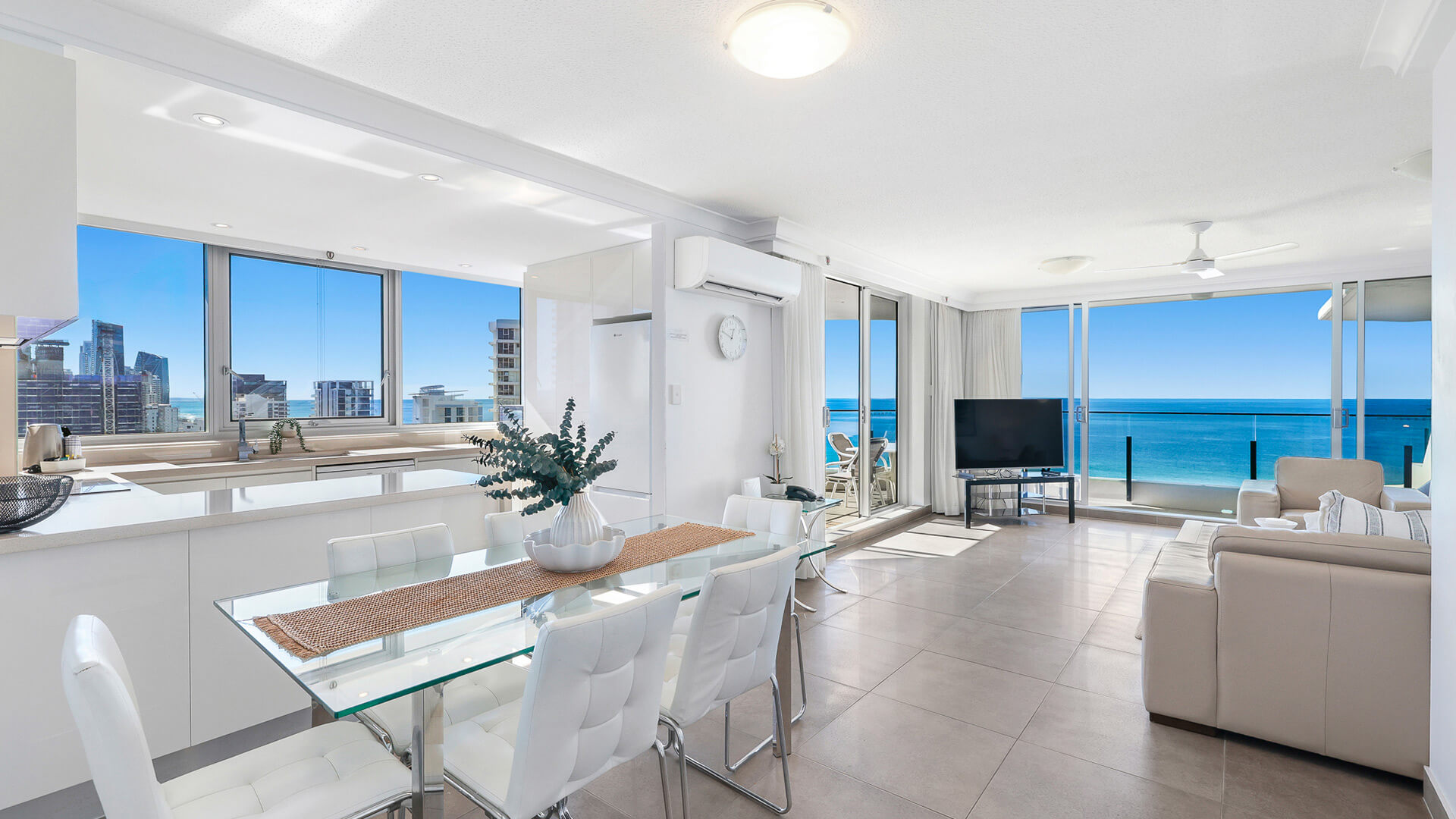 Bright and spacious open-plan living, dining, and kitchen area in the 2 Bedroom Ocean View Apartment at ULTIQA Beach Haven with panoramic ocean views and modern furnishings.