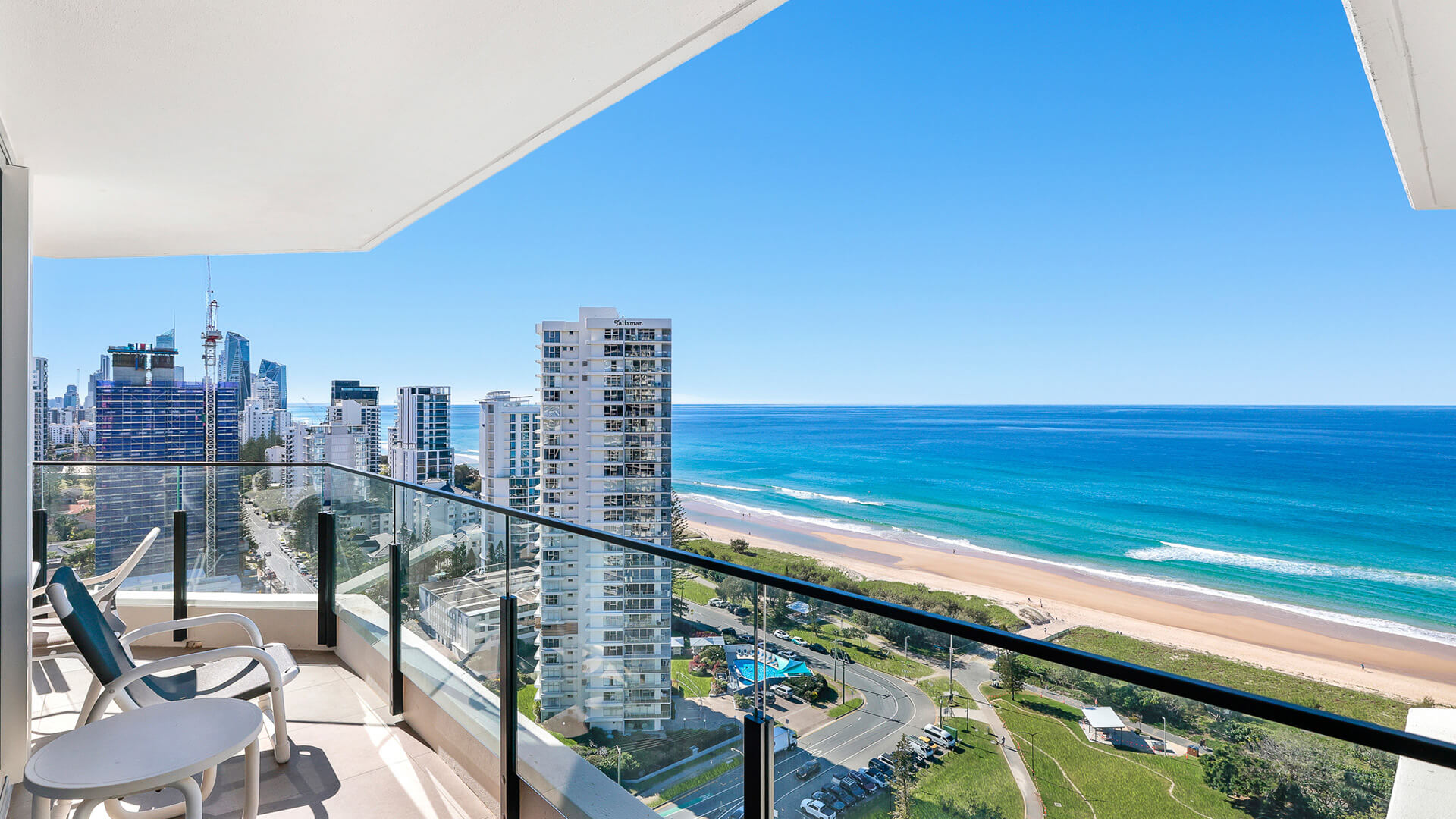 Private balcony in the 2 Bedroom Ocean View Apartment at ULTIQA Beach Haven, overlooking the Gold Coast coastline with outdoor seating and sweeping views of the beach, ocean, and city skyline.