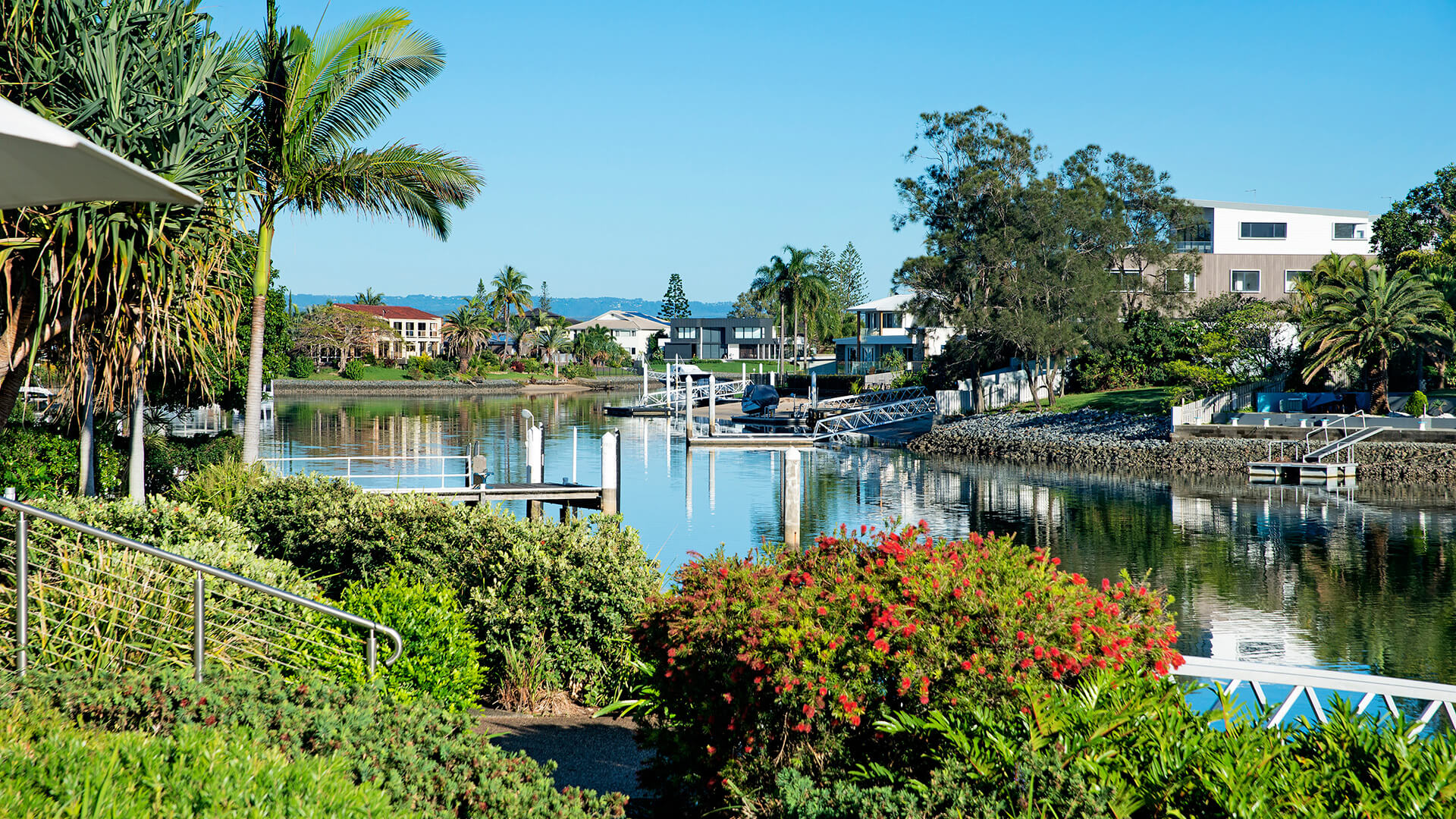 Lush gardens and canal views at ULTIQA Freshwater Point Resort, Broadbeach.