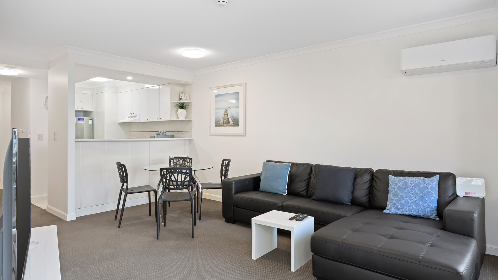 Open-plan living and dining area with modern furnishings and a fully equipped kitchen.