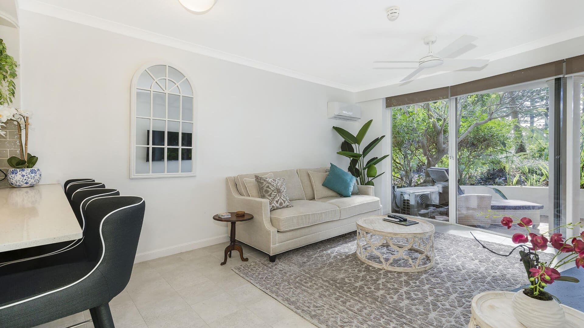 Spacious lounge in 1 Bedroom Superior Apartment at ULTIQA Burleigh Mediterranean Resort with garden views and outdoor access.