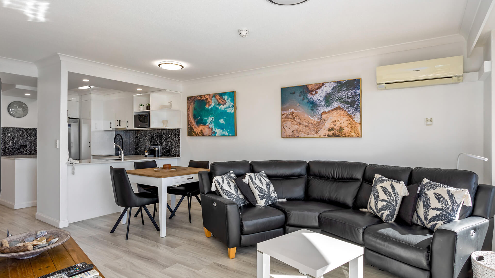 Modern open-plan kitchen, dining, and lounge area in 1 Bedroom Superior Ocean View Apartment at ULTIQA Burleigh Mediterranean Resort.