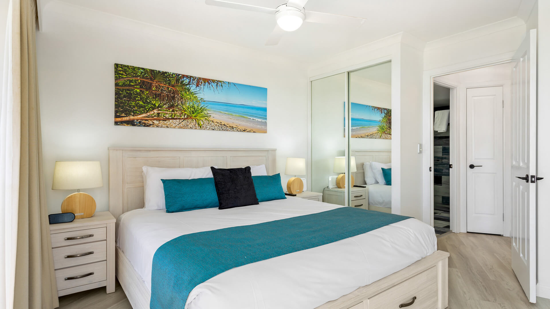 Bedroom in 1 Bedroom Superior Ocean View Apartment at ULTIQA Burleigh Mediterranean Resort with king bed and beach-themed decor.