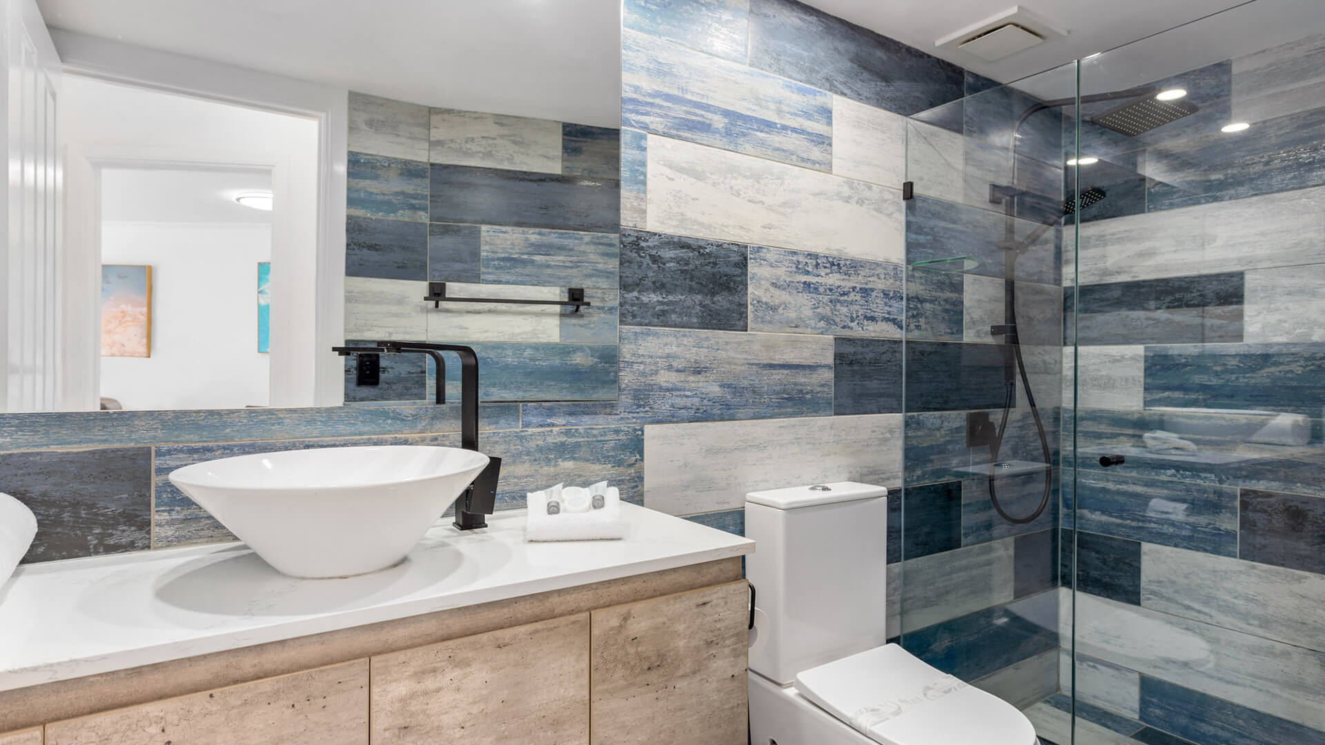 Modern bathroom with walk-in shower in 1 Bedroom Superior Ocean View Apartment at ULTIQA Burleigh Mediterranean Resort.