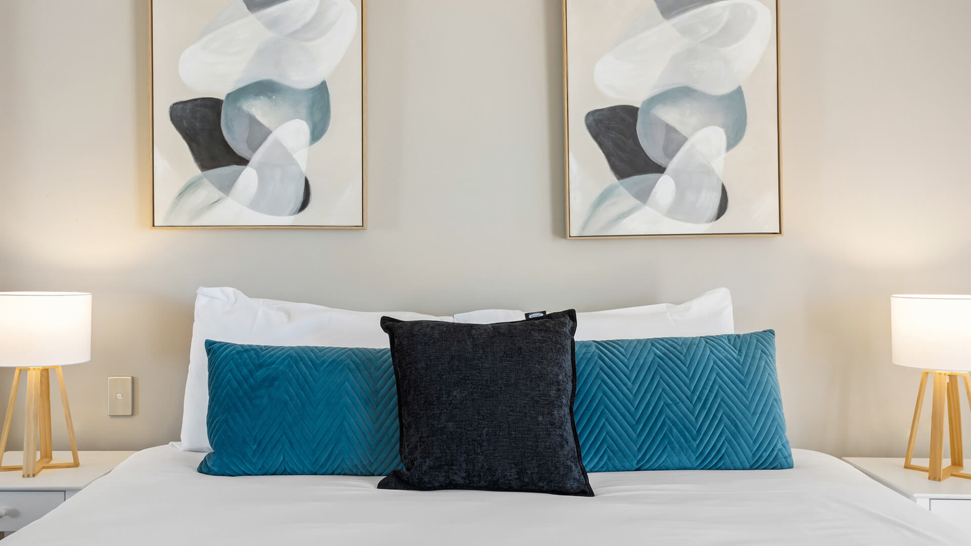 King bed with modern decor in 2 Bedroom Garden View Apartment at ULTIQA Burleigh Mediterranean Resort.