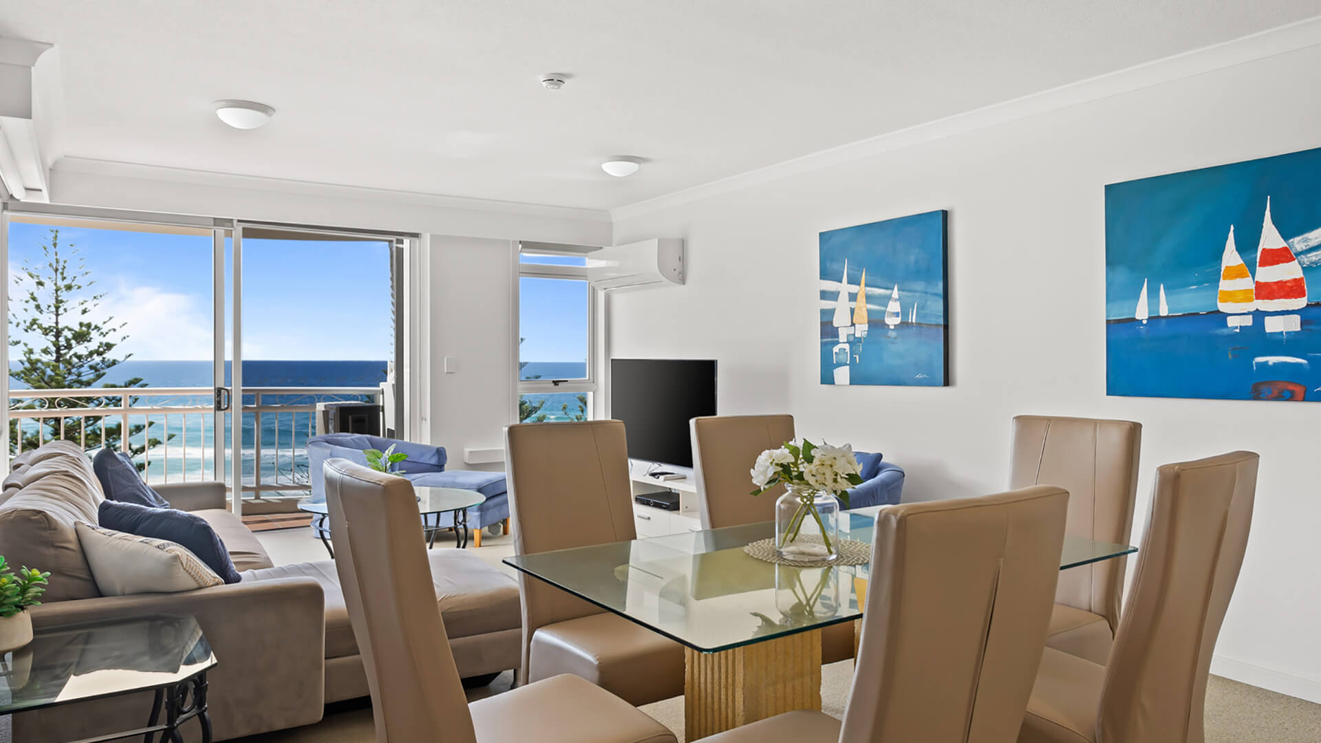 Dining and lounge area with ocean views in 2 Bedroom Apartment at ULTIQA Burleigh Mediterranean Resort.