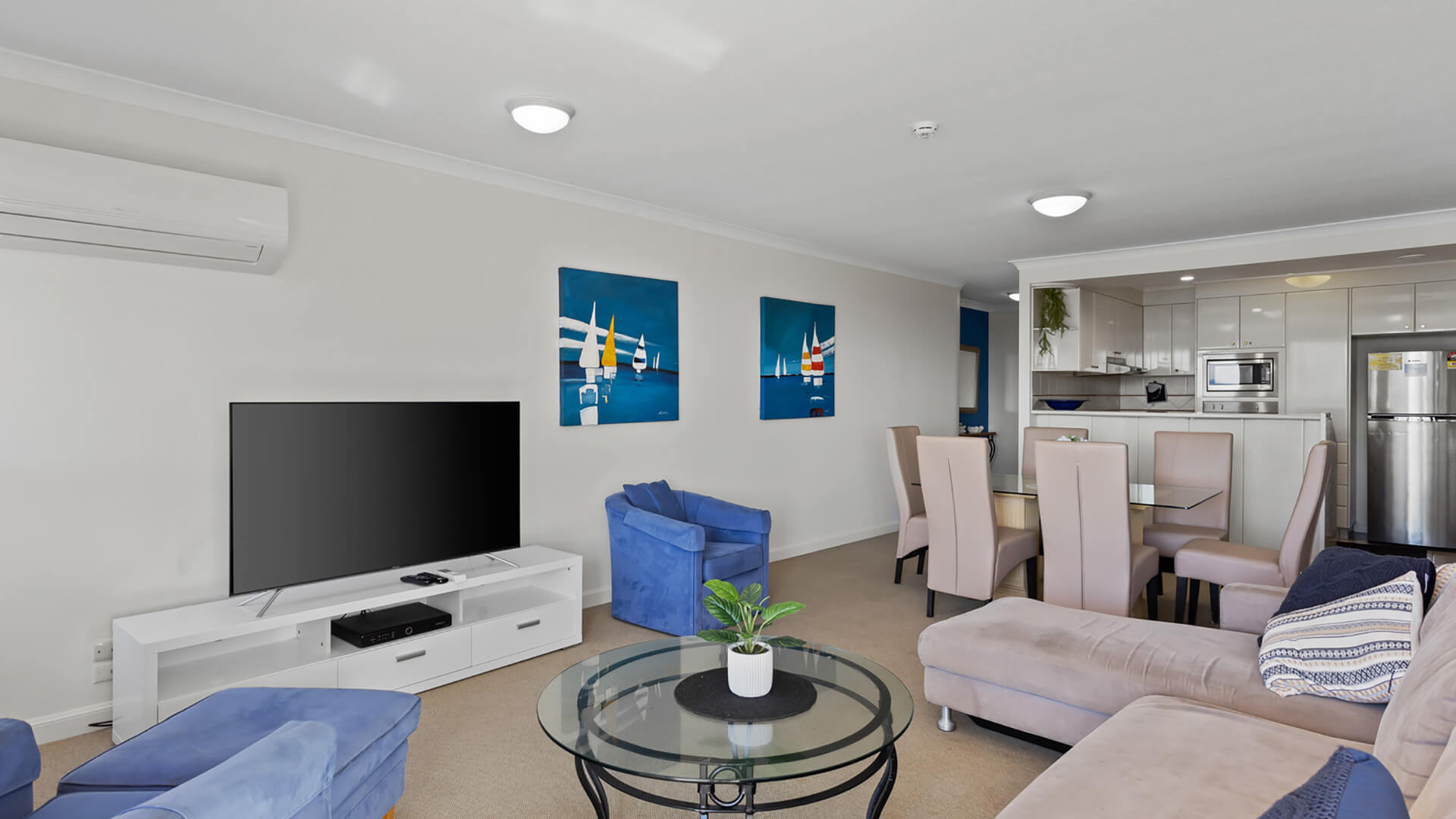 Open-plan lounge, dining, and kitchen area in 2 Bedroom Apartment at ULTIQA Burleigh Mediterranean Resort.
