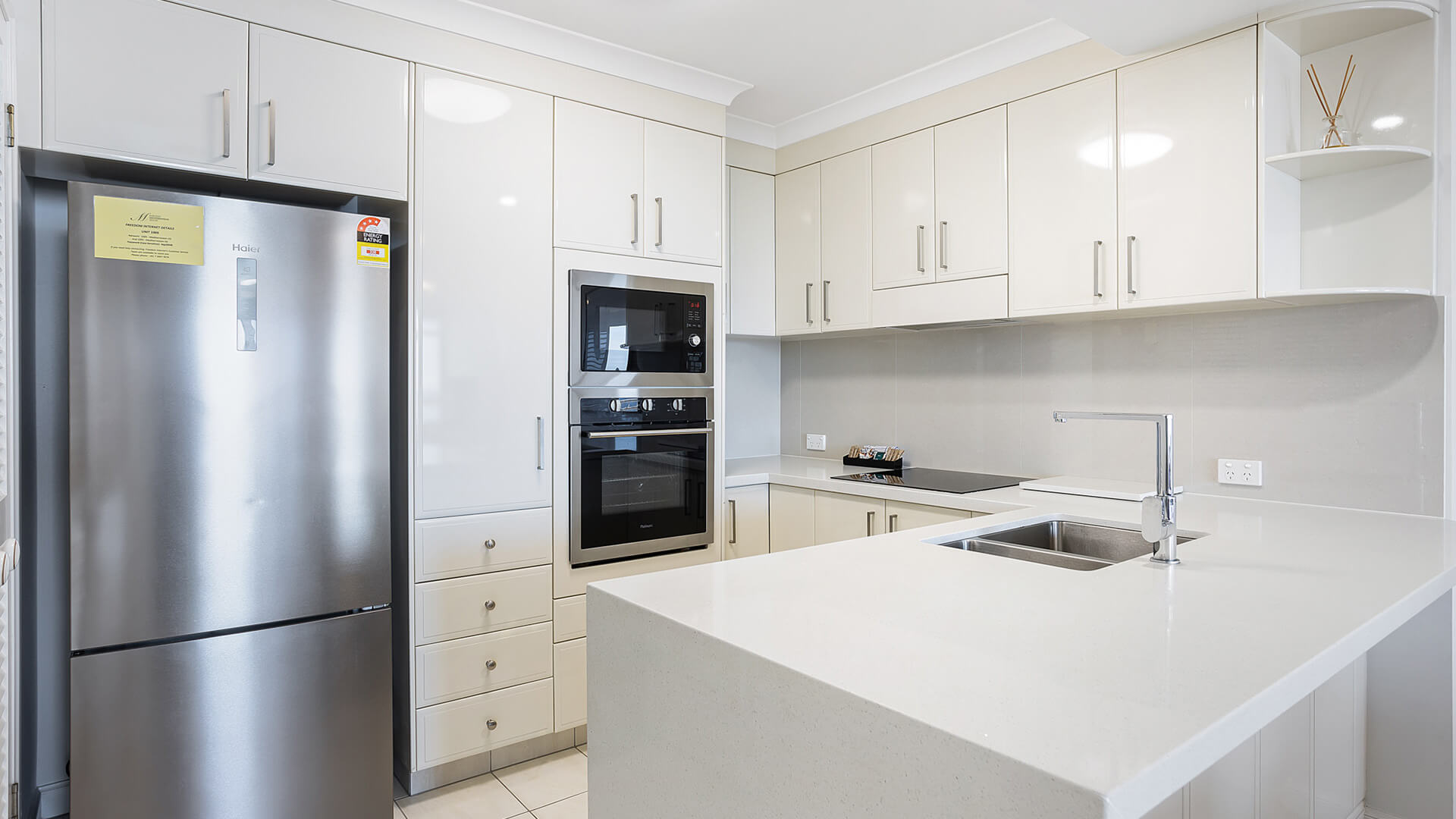 Modern fully equipped kitchen in 2 Bedroom Apartment at ULTIQA Burleigh Mediterranean Resort.