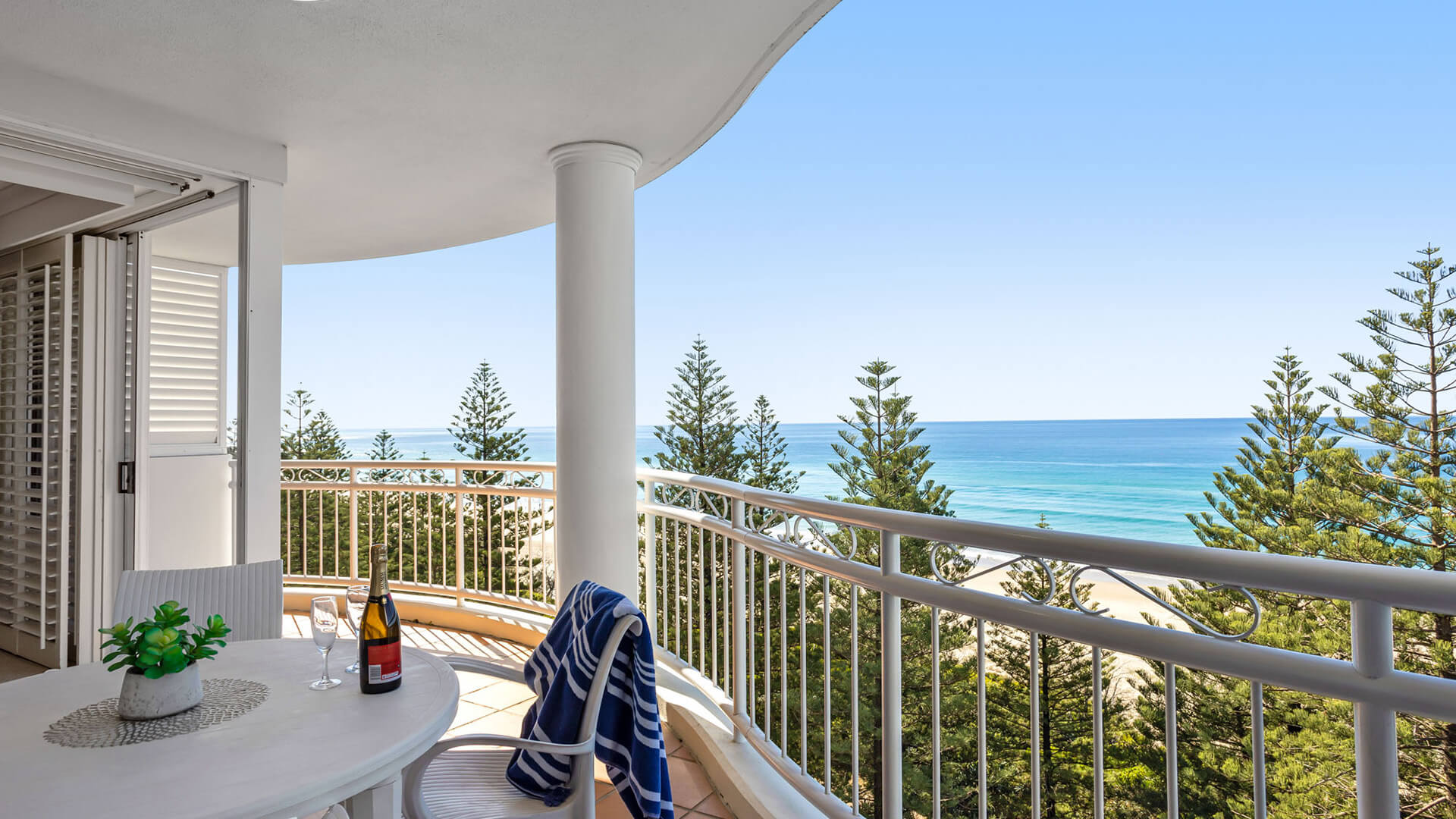 Private balcony with outdoor seating and ocean views in 2 Bedroom Apartment at ULTIQA Burleigh Mediterranean Resort.