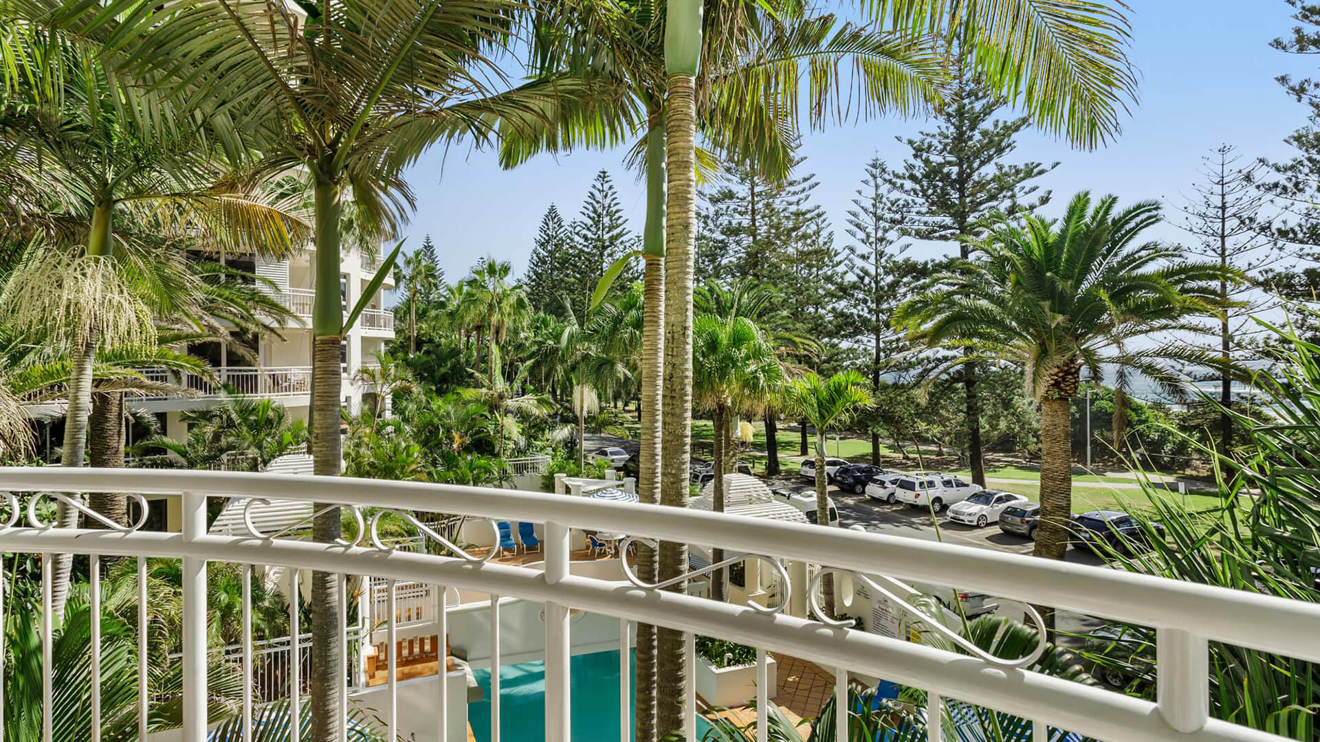 Garden-view balcony overlooking pool and tropical greenery at ULTIQA Burleigh Mediterranean Resort.