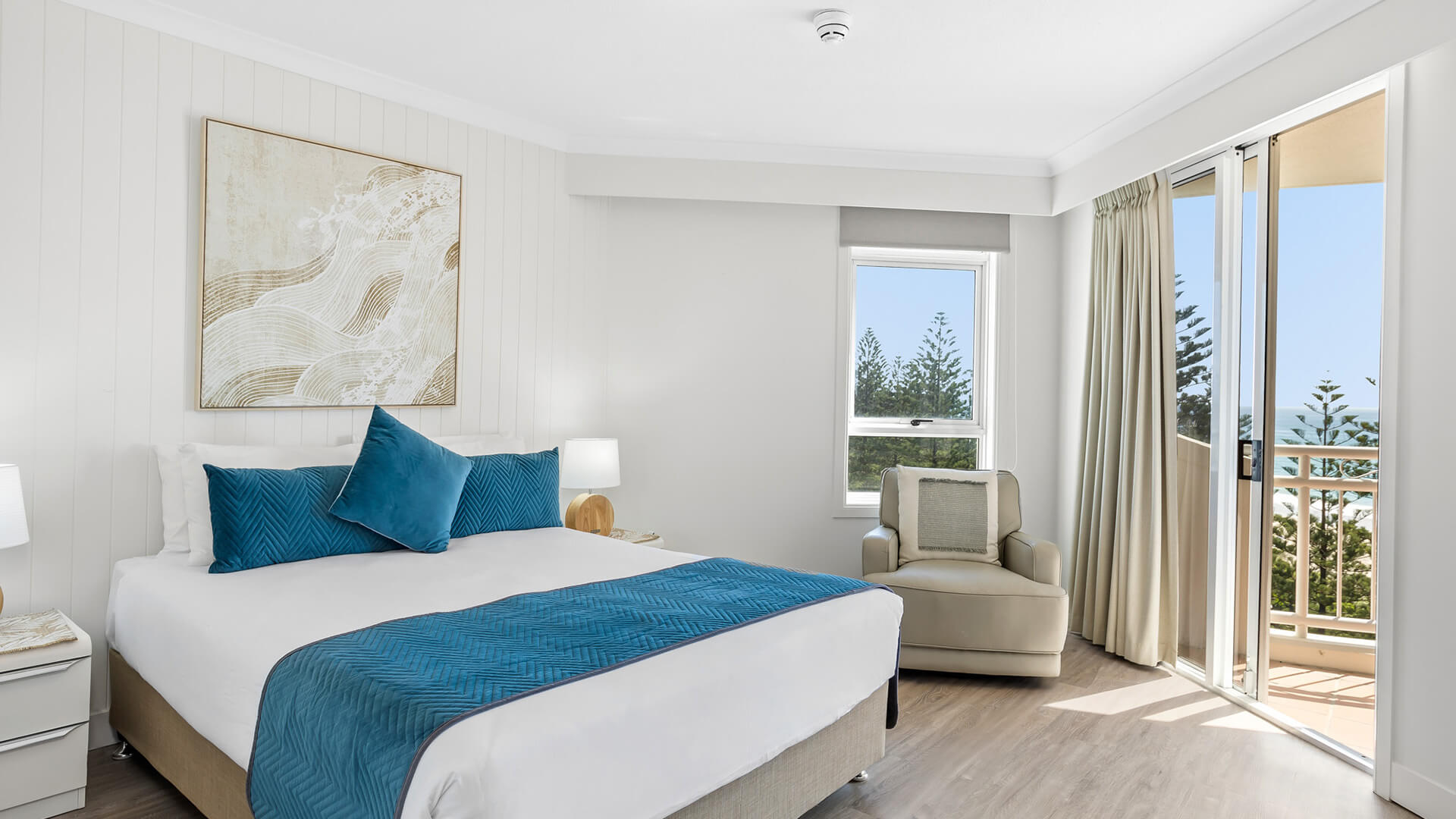 Bedroom with ocean-view balcony in 2 Bedroom Superior Ocean View Apartment at ULTIQA Burleigh Mediterranean Resort.