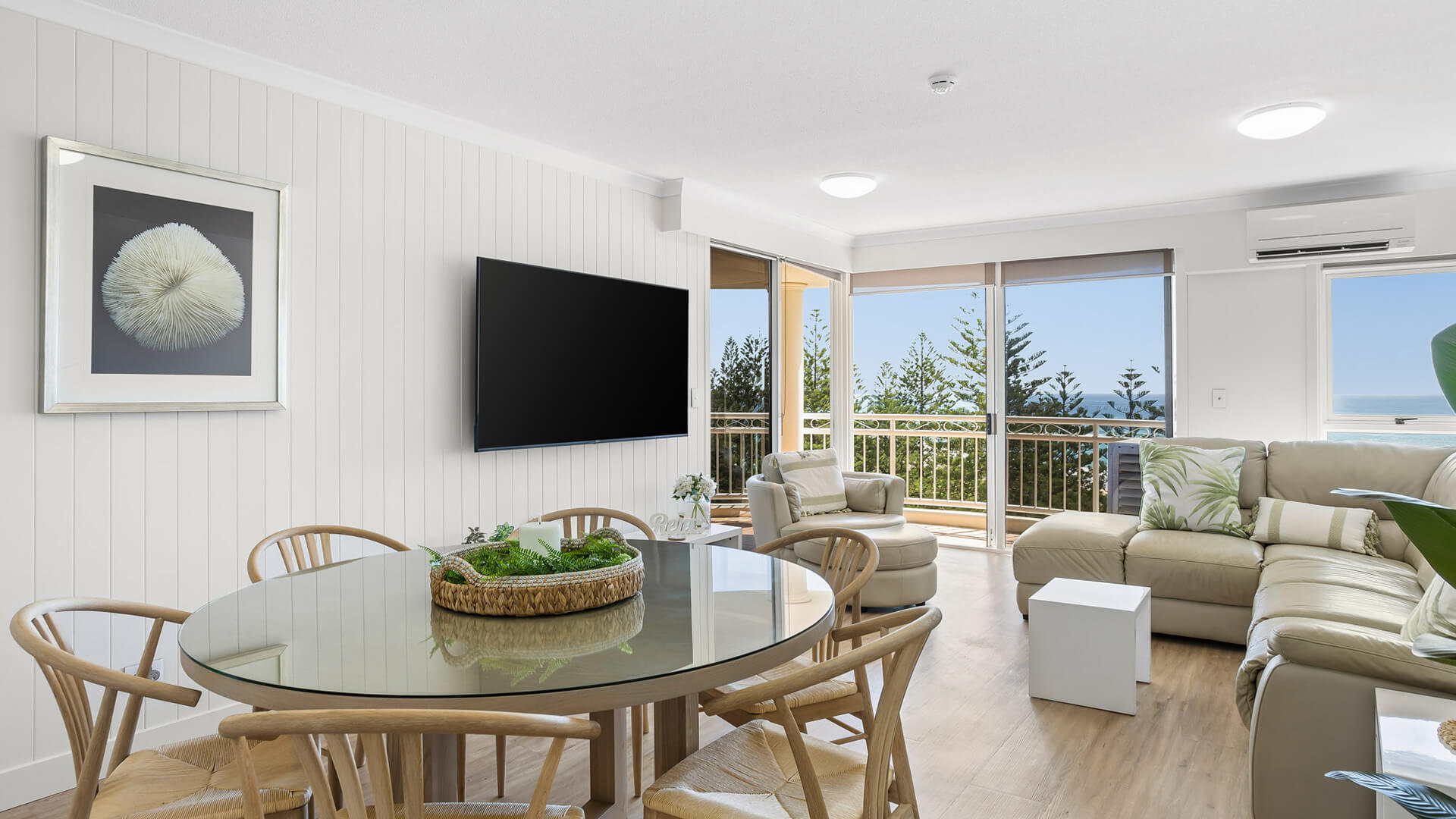 Open-plan living and dining area with ocean views in 2 Bedroom Superior Ocean View Apartment at ULTIQA Burleigh Mediterranean Resort.