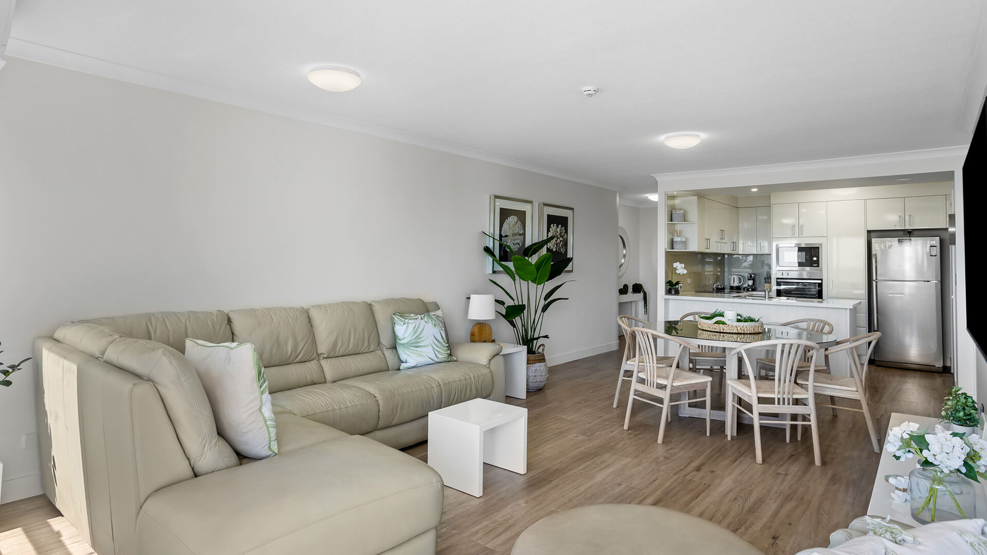 Spacious living and dining area with full kitchen in 2 Bedroom Superior Ocean View Apartment at ULTIQA Burleigh Mediterranean Resort.