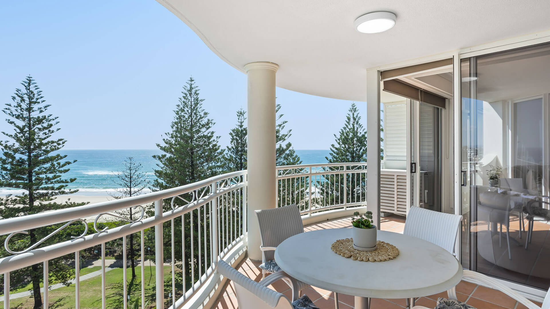 Private balcony with outdoor seating and stunning ocean views from the 2 Bedroom Superior Ocean View Apartment at ULTIQA Burleigh Mediterranean Resort.
