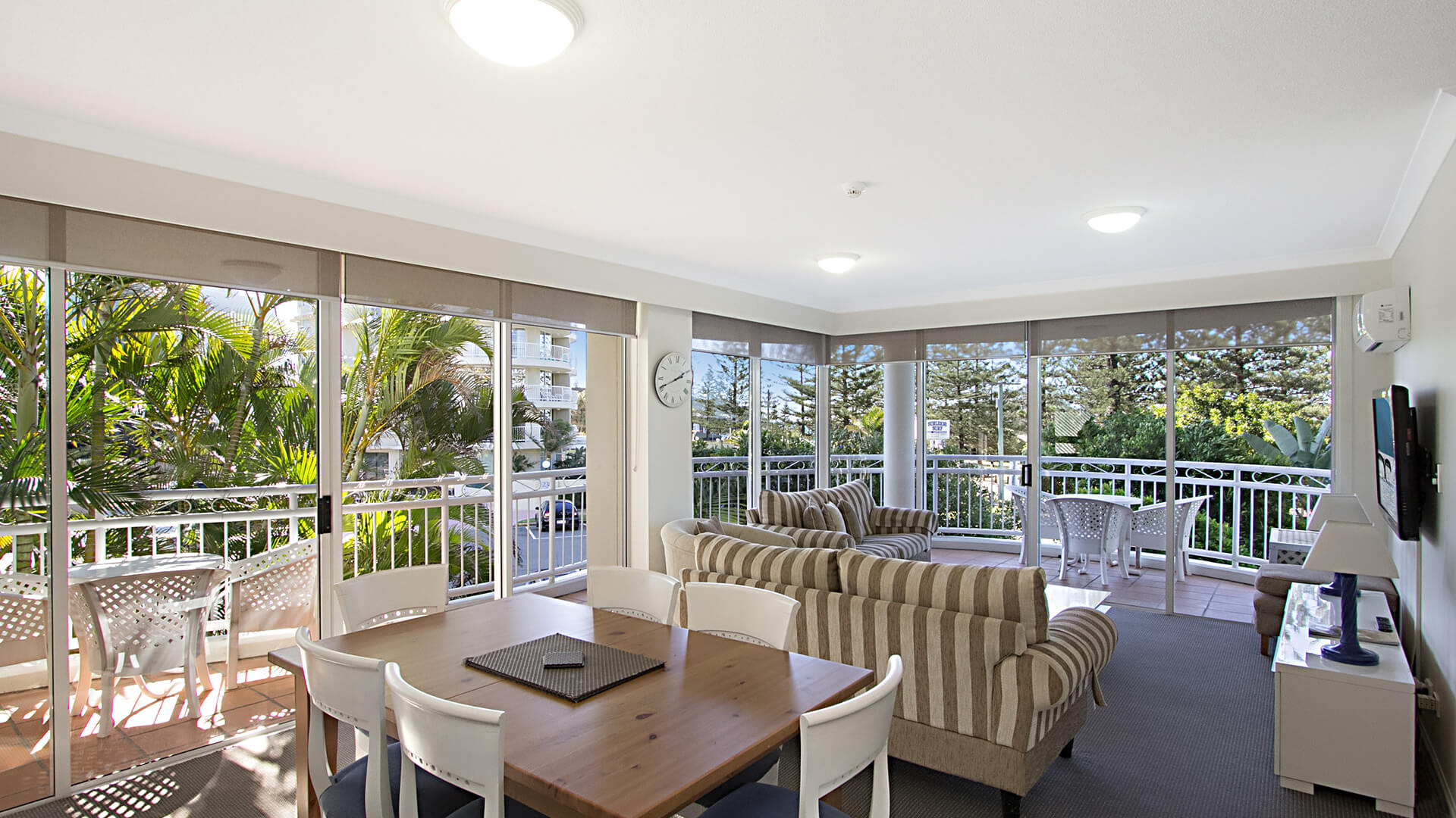 Open-plan living and dining area in 3 Bedroom Apartment at ULTIQA Burleigh Mediterranean Resort.
