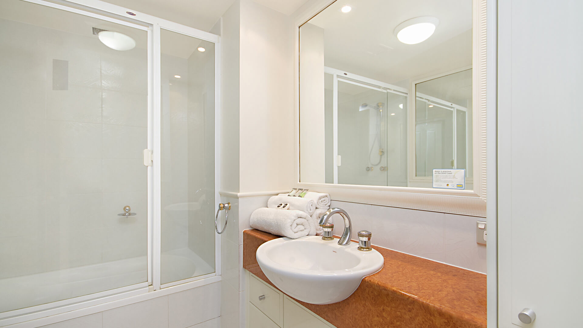 Bathroom with shower over bath in 3 Bedroom Apartment at ULTIQA Burleigh Mediterranean Resort.