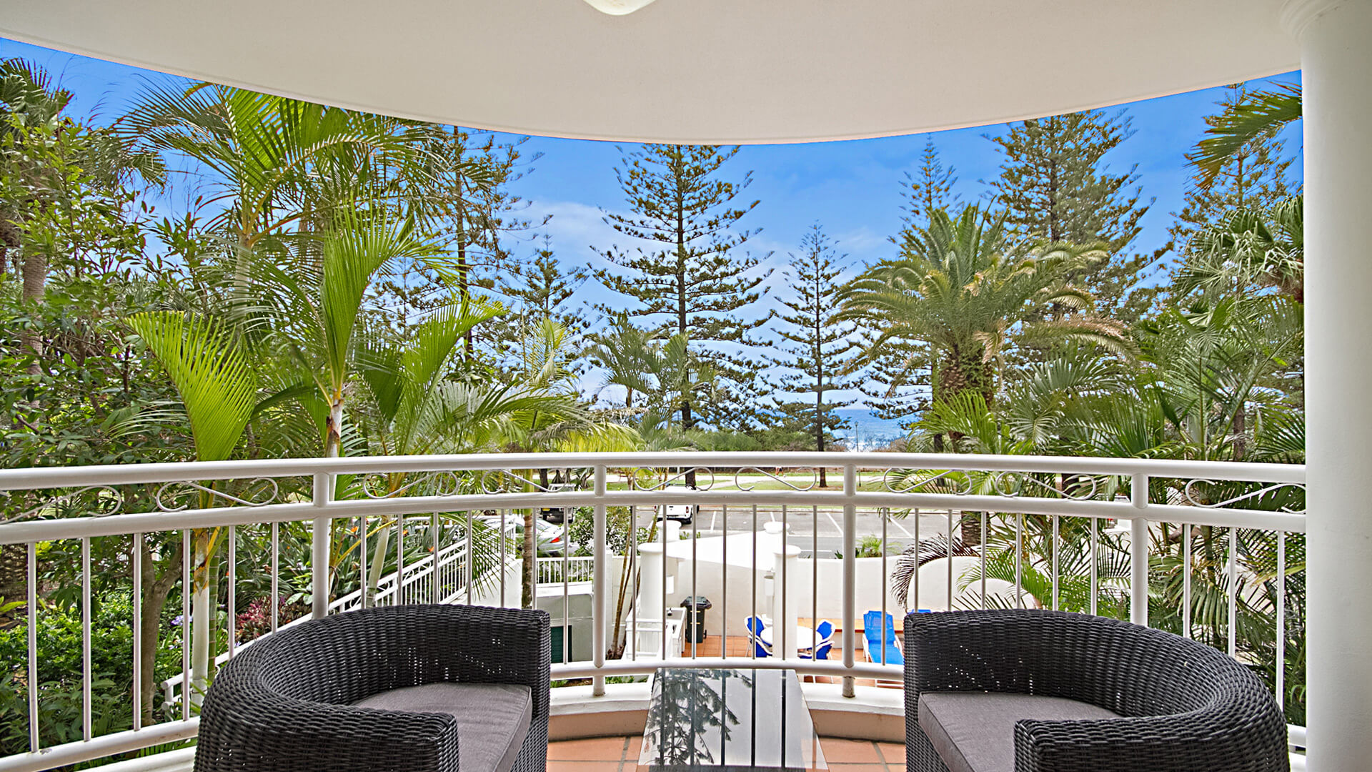 Private balcony with outdoor seating and garden views in 3 Bedroom Apartment at ULTIQA Burleigh Mediterranean Resort.