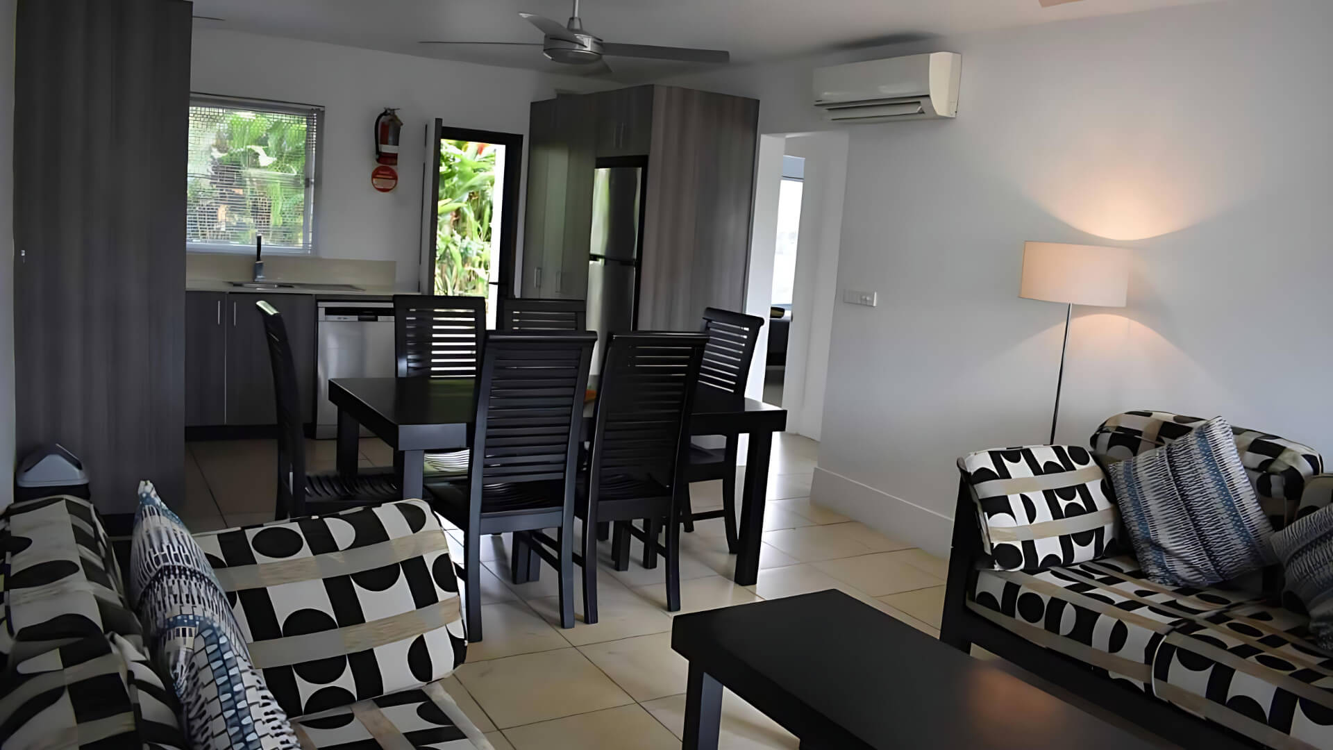 Standard 2 Bedroom 1 Bathroom Apartment at ULTIQA Fiji with living area, dining table, and full kitchen.
