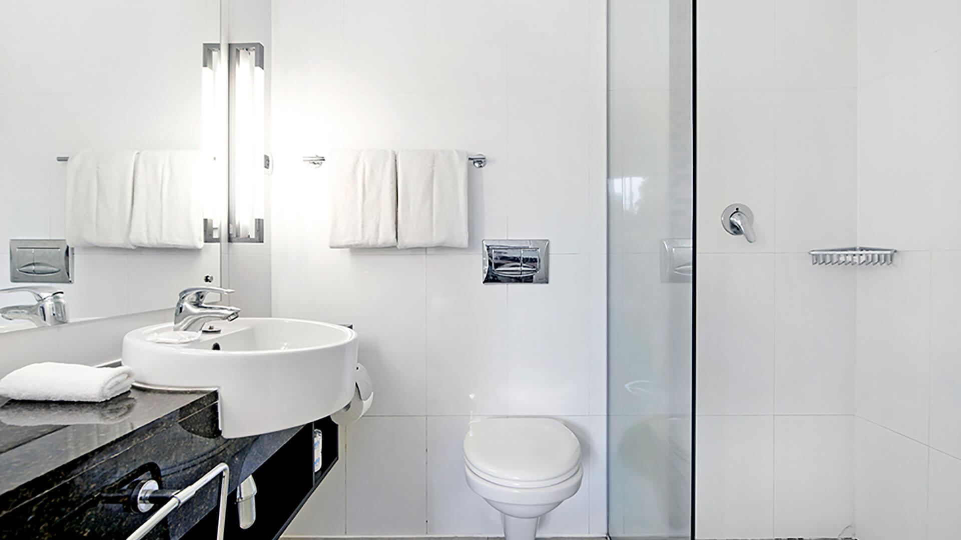 Modern bathroom with walk-in shower, sleek vanity, and fresh white towels in 2 Bedroom Apartment at ULTIQA Fiji.