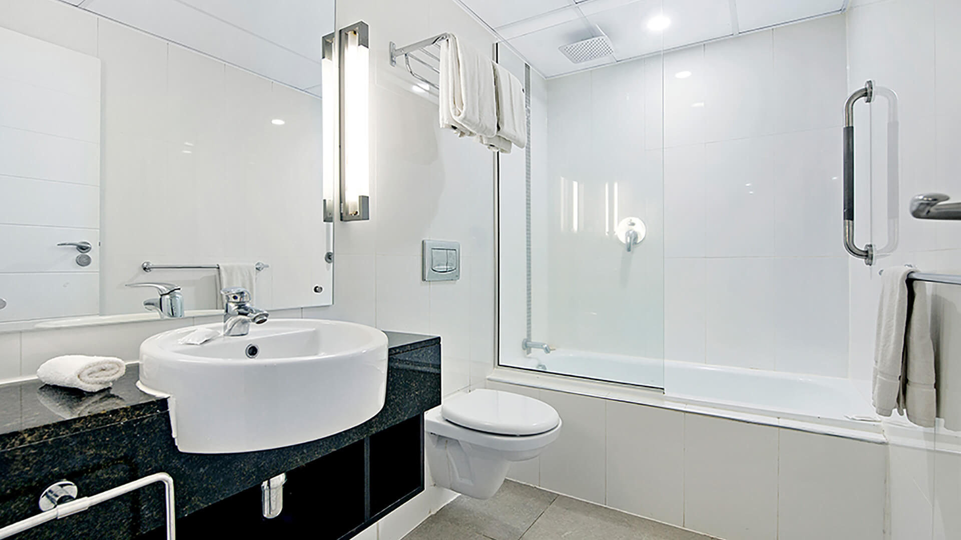 Modern bathroom with bathtub and overhead shower in 2 Bedroom Apartment at ULTIQA Fiji.