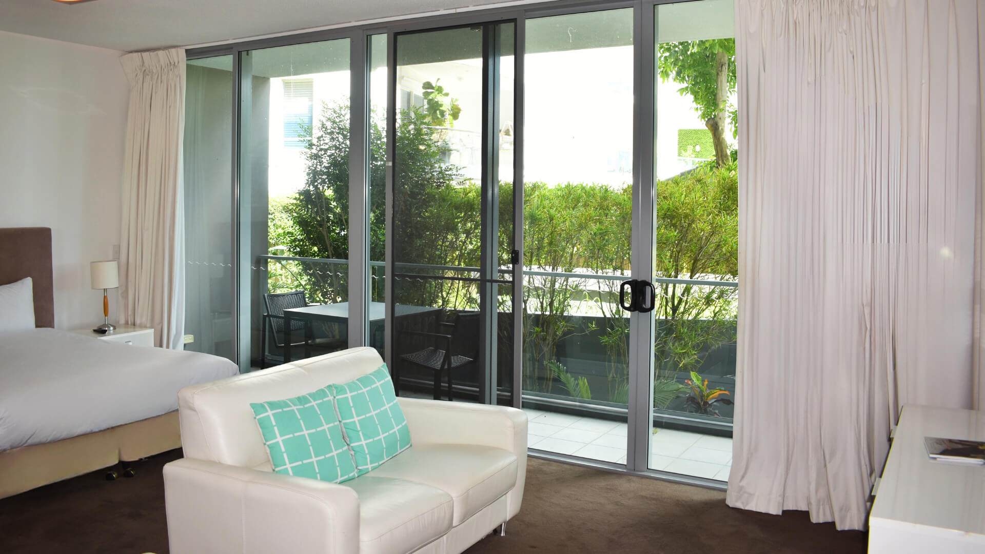 Studio at ULTIQA Freshwater Point Resort featuring a lounge, bed, and private balcony with garden views.