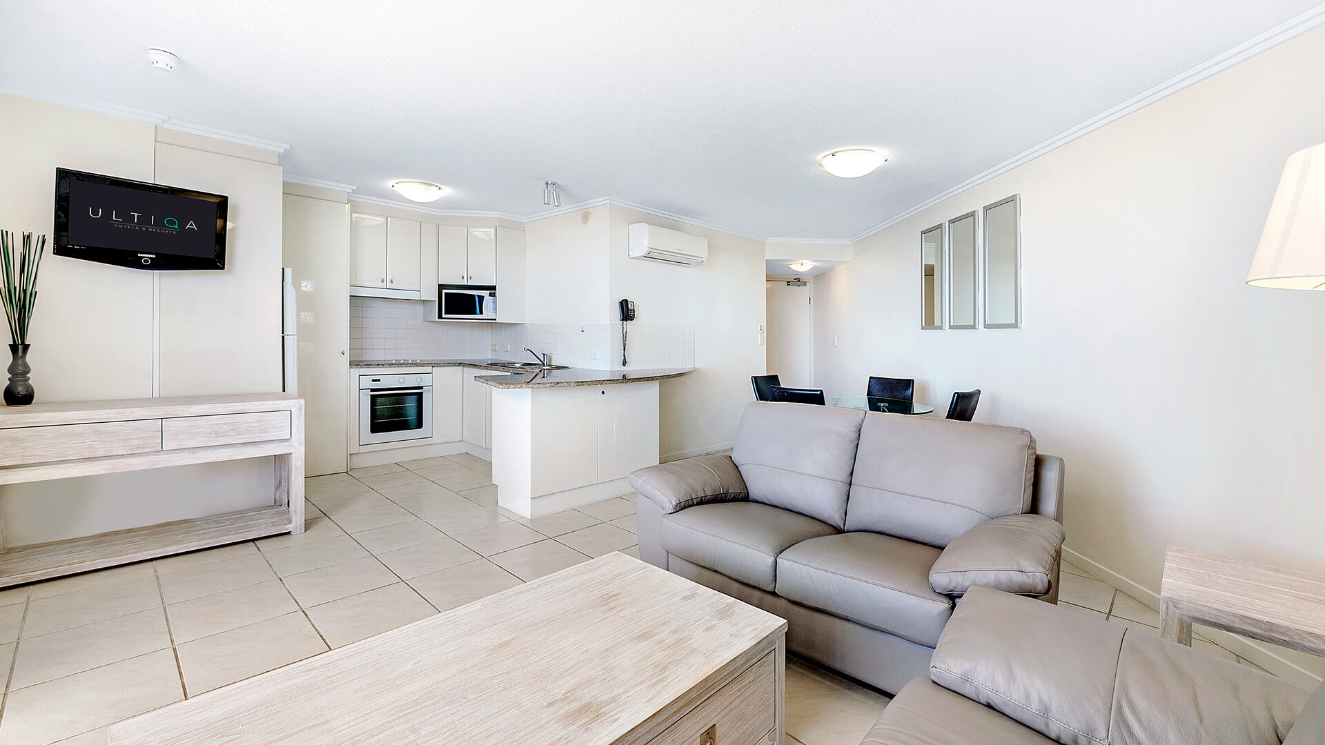 Open-plan living, dining, and kitchen area in 1 Bedroom Apartment at ULTIQA Shearwater Resort.