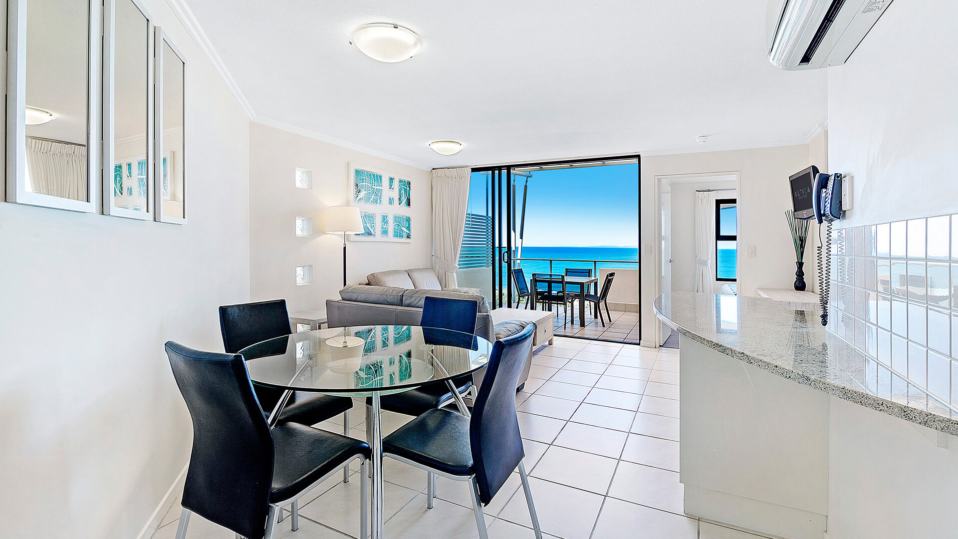 Dining area and kitchen with ocean views in 1 Bedroom Apartment at ULTIQA Shearwater Resort.