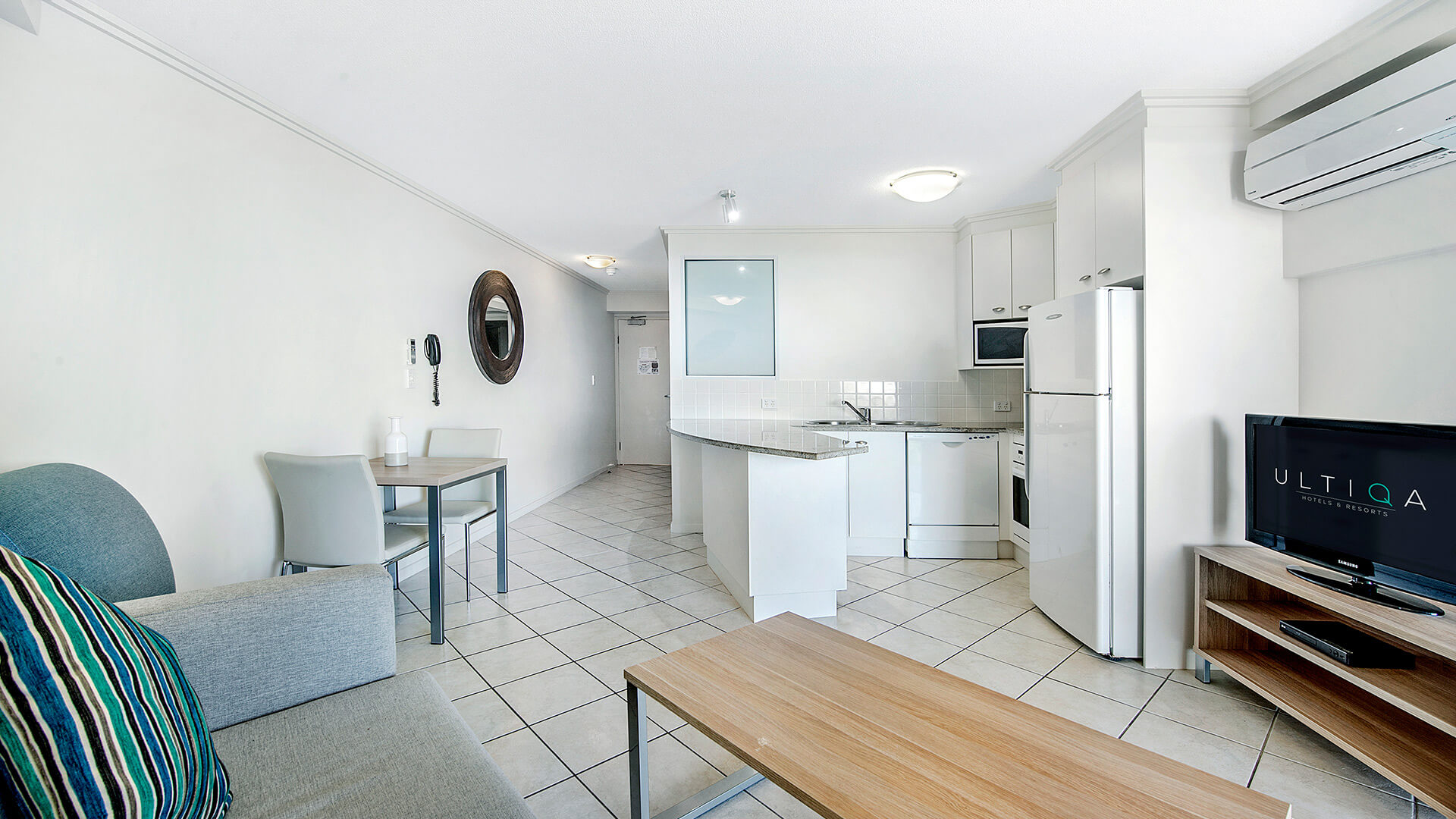 Open-plan living, dining, and kitchen area in 1 Bedroom Apartment at ULTIQA Shearwater Resort.