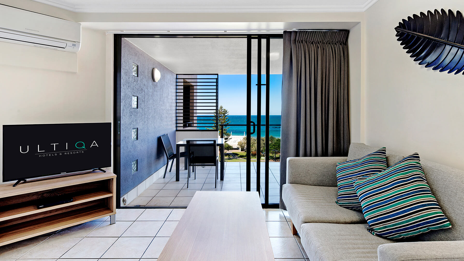 Living area with balcony and ocean views in 1 Bedroom Apartment at ULTIQA Shearwater Resort.