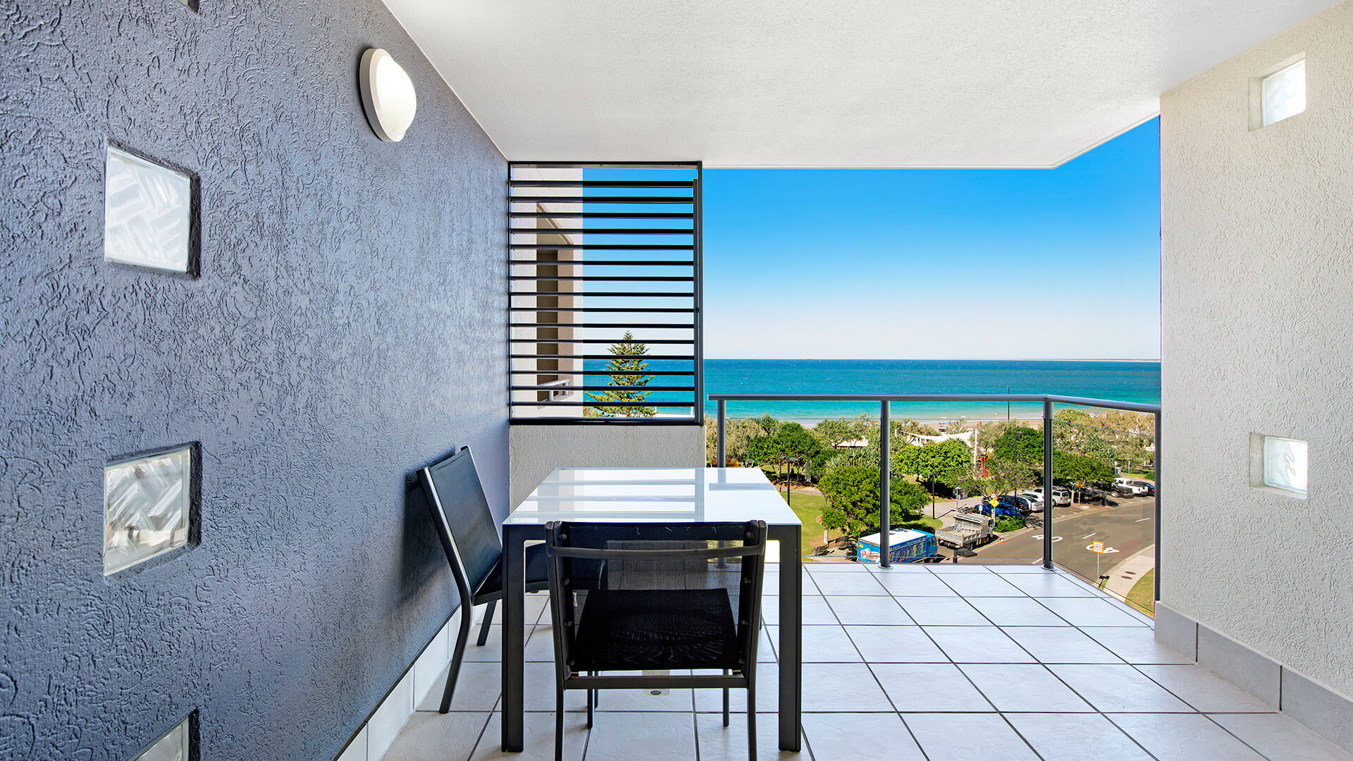 Balcony with outdoor seating and ocean views from 1 Bedroom Apartment at ULTIQA Shearwater Resort.