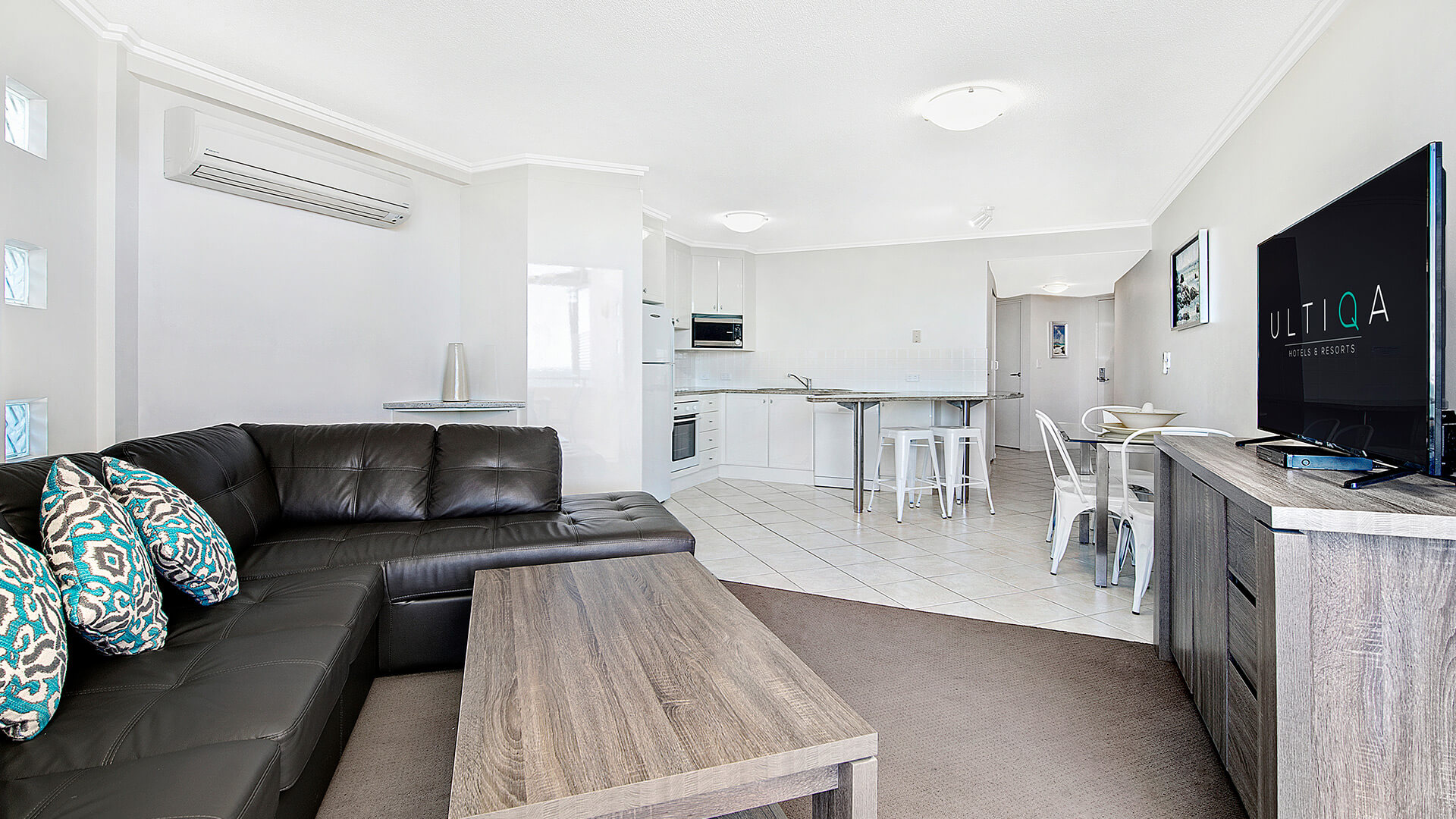 Open-plan living and kitchen area in 2 Bedroom 1 Bathroom Apartment at ULTIQA Shearwater Resort.