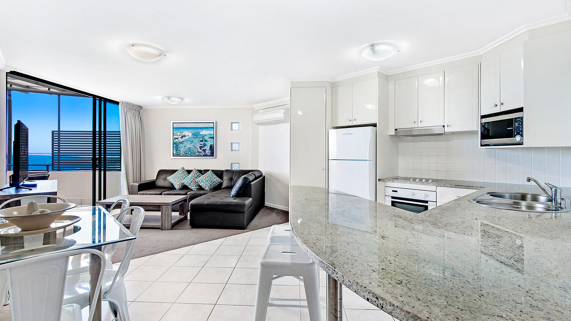 Kitchen and dining area with ocean-view living space in 2 Bedroom 1 Bathroom Apartment at ULTIQA Shearwater Resort.