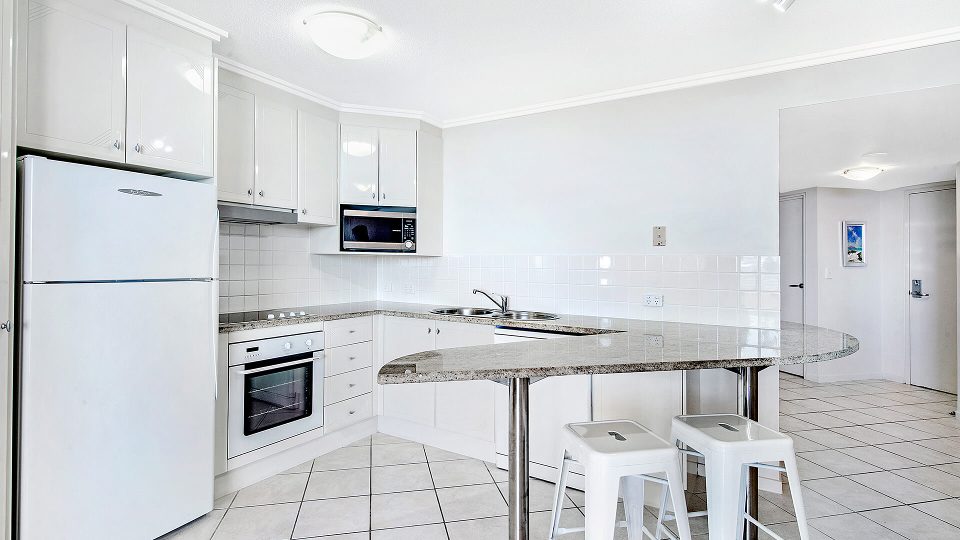 Full kitchen with breakfast bar in 2 Bedroom 1 Bathroom Apartment at ULTIQA Shearwater Resort.