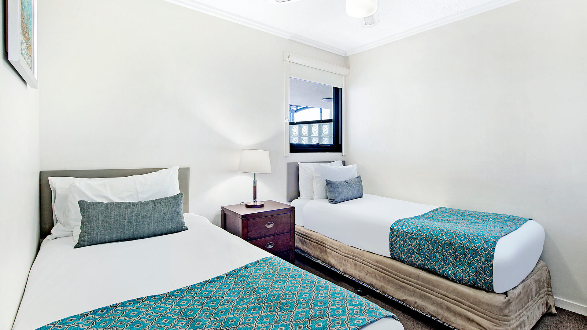 Second bedroom with twin beds in 2 Bedroom 1 Bathroom Apartment at ULTIQA Shearwater Resort.