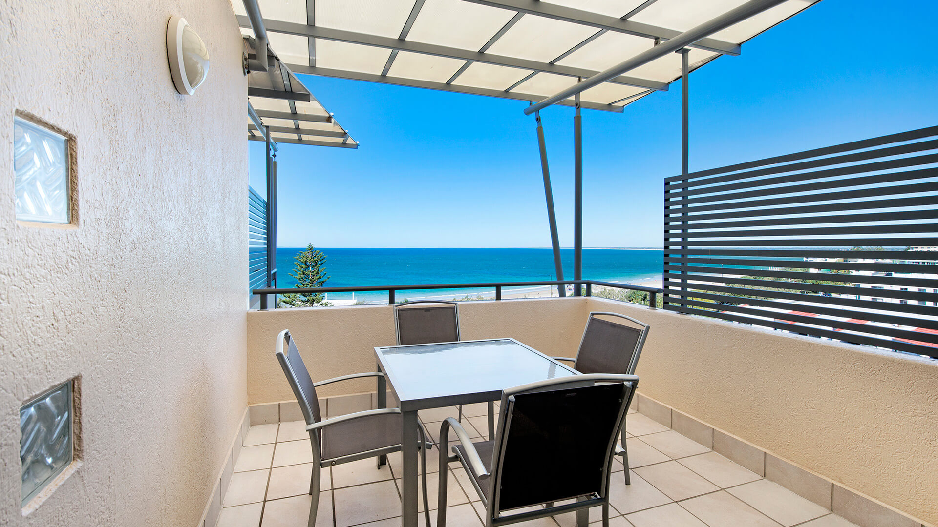 Private balcony with outdoor dining and ocean views in 2 Bedroom 1 Bathroom Apartment at ULTIQA Shearwater Resort.