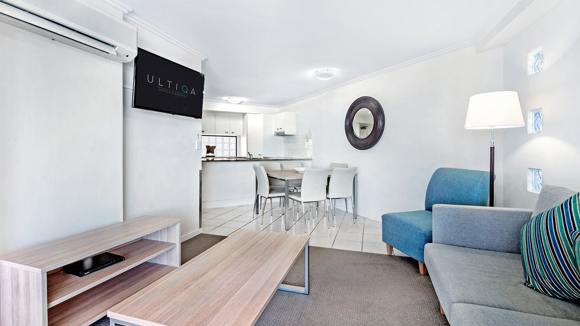 Open-plan living and dining area with TV and seating in 2 Bedroom Apartment at ULTIQA Shearwater Resort.