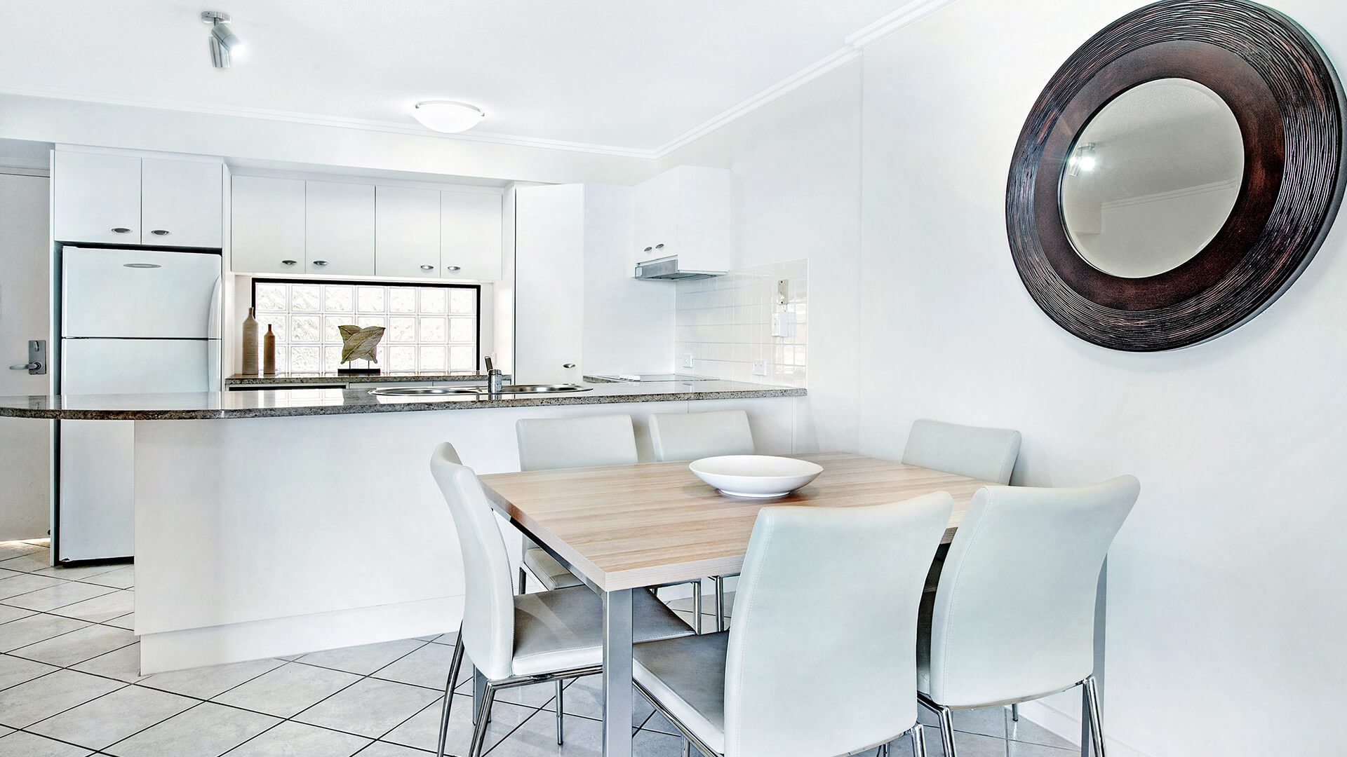 Dining area and kitchen in 2 Bedroom Apartment at ULTIQA Shearwater Resort.