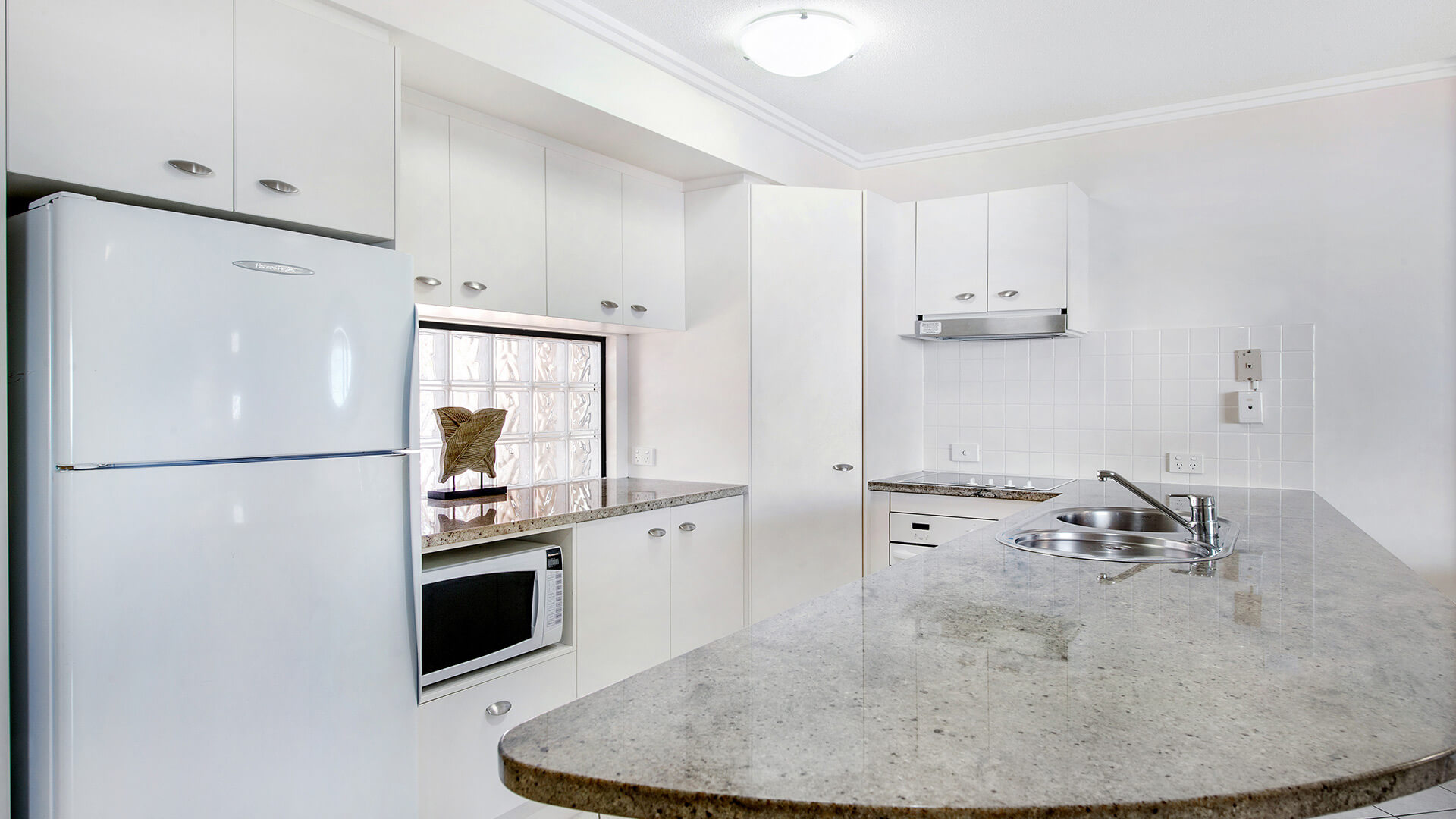 Fully equipped kitchen with modern appliances in 2 Bedroom Apartment at ULTIQA Shearwater Resort.