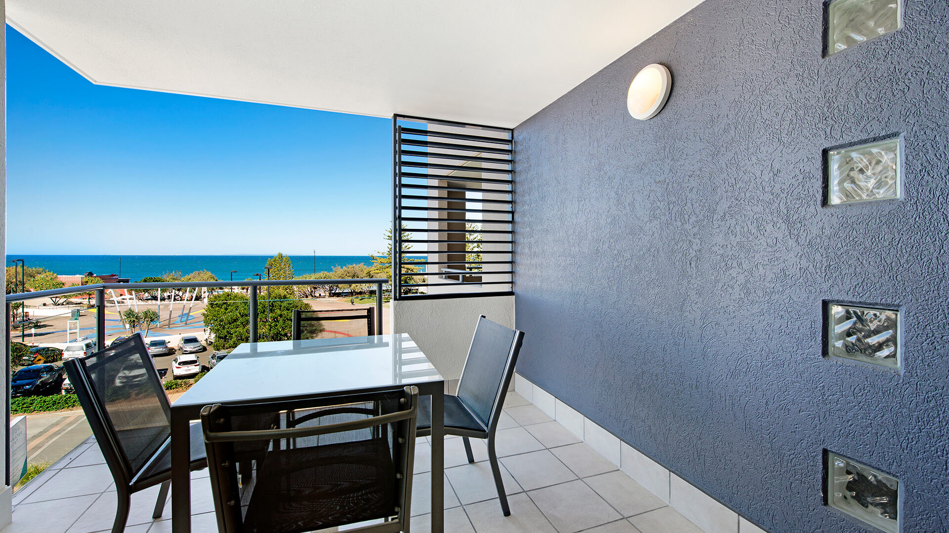Private balcony with outdoor seating and ocean views in 2 Bedroom Apartment at ULTIQA Shearwater Resort.